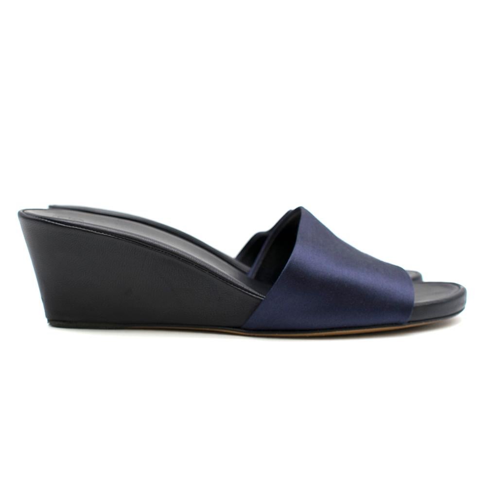 The Row Blue suede slip on wedges.

-Black leather insole and sole,
-Blue suede single thick strap with leather lining,
-Open toe shoe
-Wedged heel
-Slip on
-Dust bag included

Please note, these items are pre-owned and may show some signs of