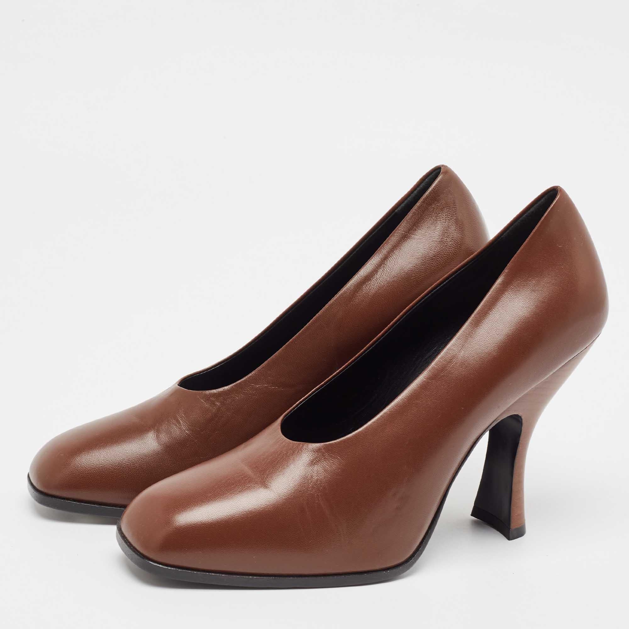 Discover the timeless sophistication of The Row pumps. Crafted from luxurious brown leather these pumps feature a sleek silhouette and an elongated toe that seamlessly enhances any outfit. The minimalist design ensures versatility making them