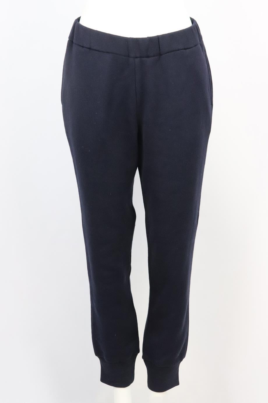 The Row cotton jersey track pants. Navy. Pull on. 100% Cotton. Size: Medium (UK 10, US 6, FR 38, IT 42). Waist: 30 in. Hips: 41 in. Length: 39.5 in. Inseam: 28.5 in. Rise: 13 in. Very good condition - As new condition, no sign of wear; see pictures.
