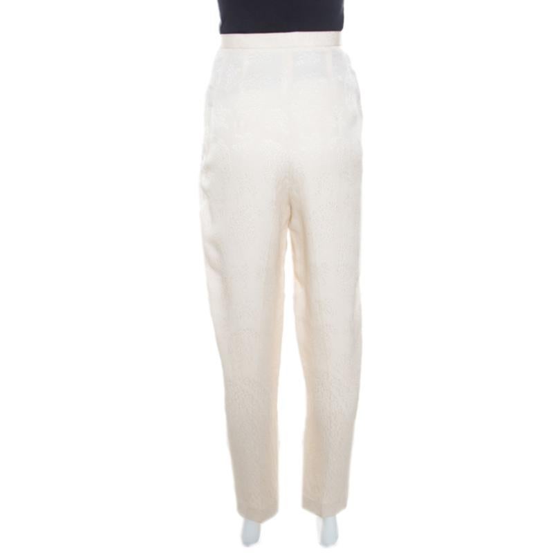 Simple and sophisticated, these cream trousers from The Row are perfect for the minimalist you! They are made of a silk and wool blend and feature a floral embossed jacquard pattern all over them. They flaunt a high waisted silhouette and come