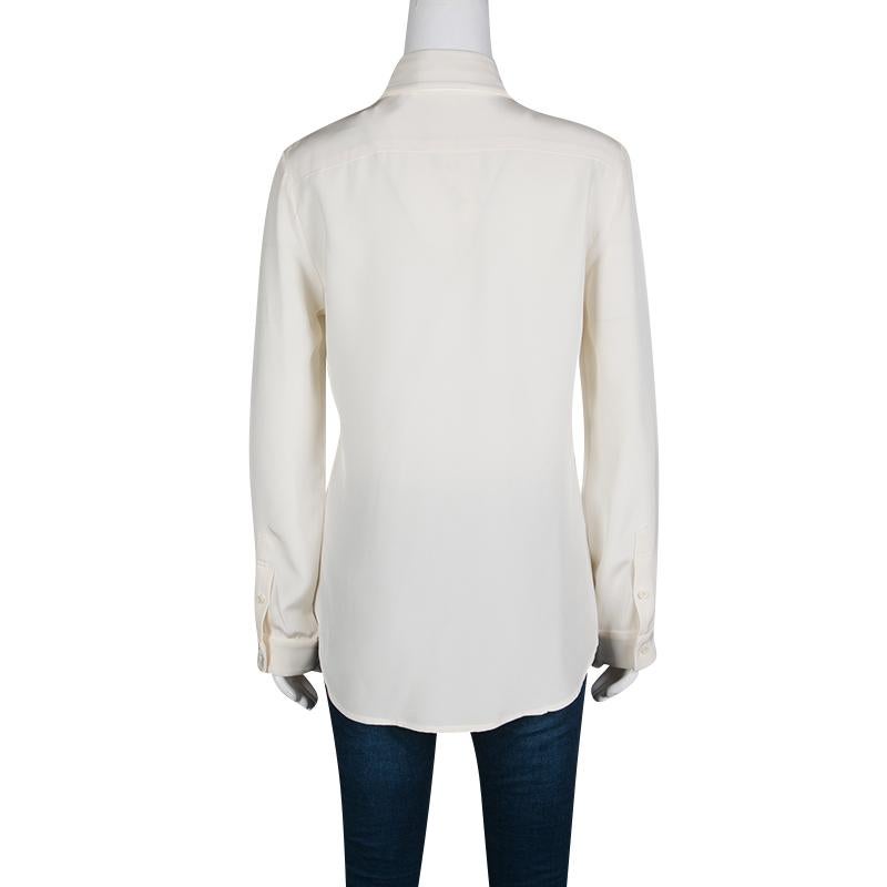 Express your unique style with this shirt from The Row. It is made from silk and features long sleeves and a cream hue. A pair of trousers and pumps will complement this shirt on any day.

Includes: The Luxury Closet Packaging

