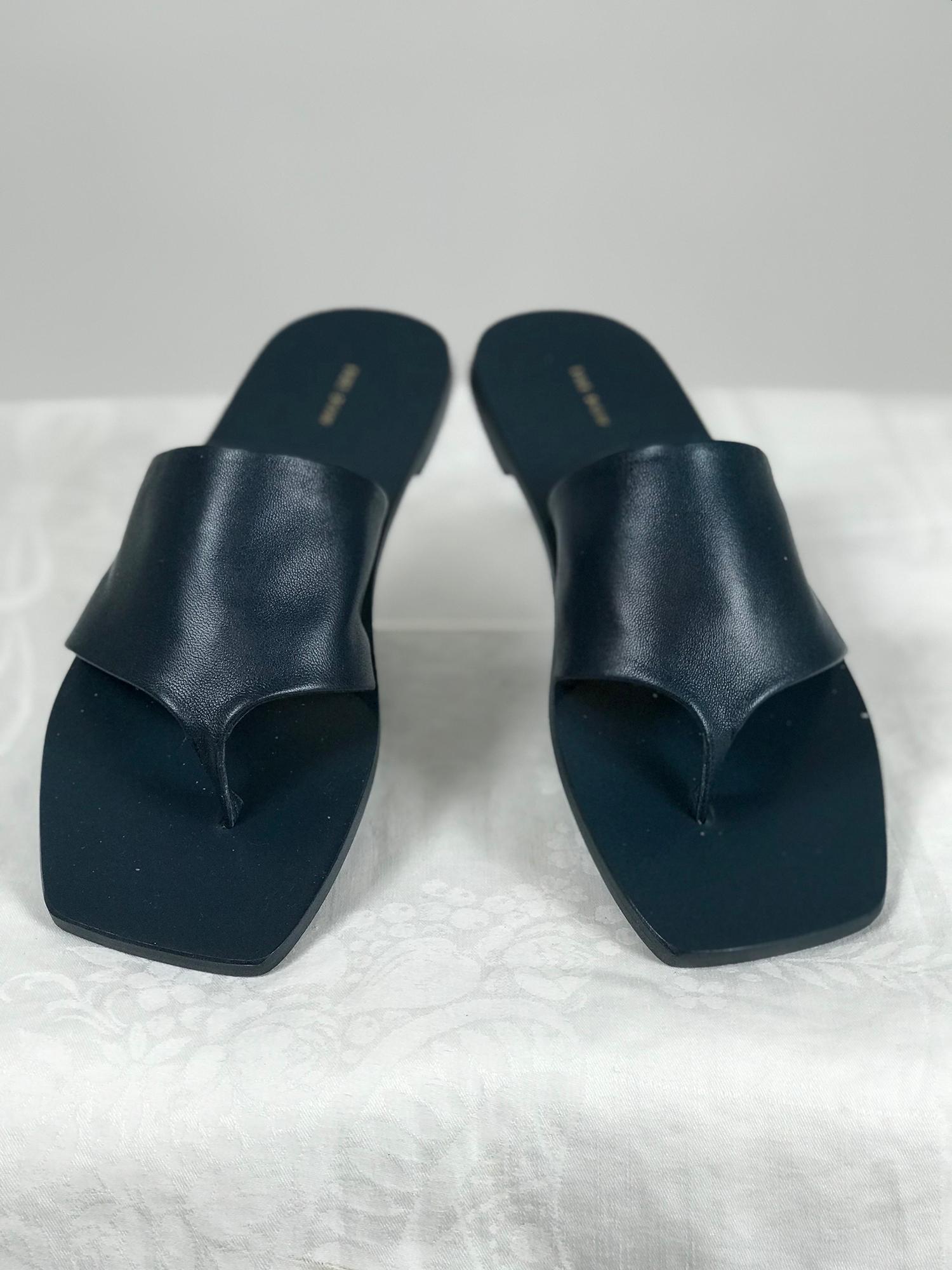 The Row flip flop flat sandal in teal (dark blue) glove soft nappa leather.
These sandals are unworn and in the box. Original tagged price $690.  Marked size 7B. 
