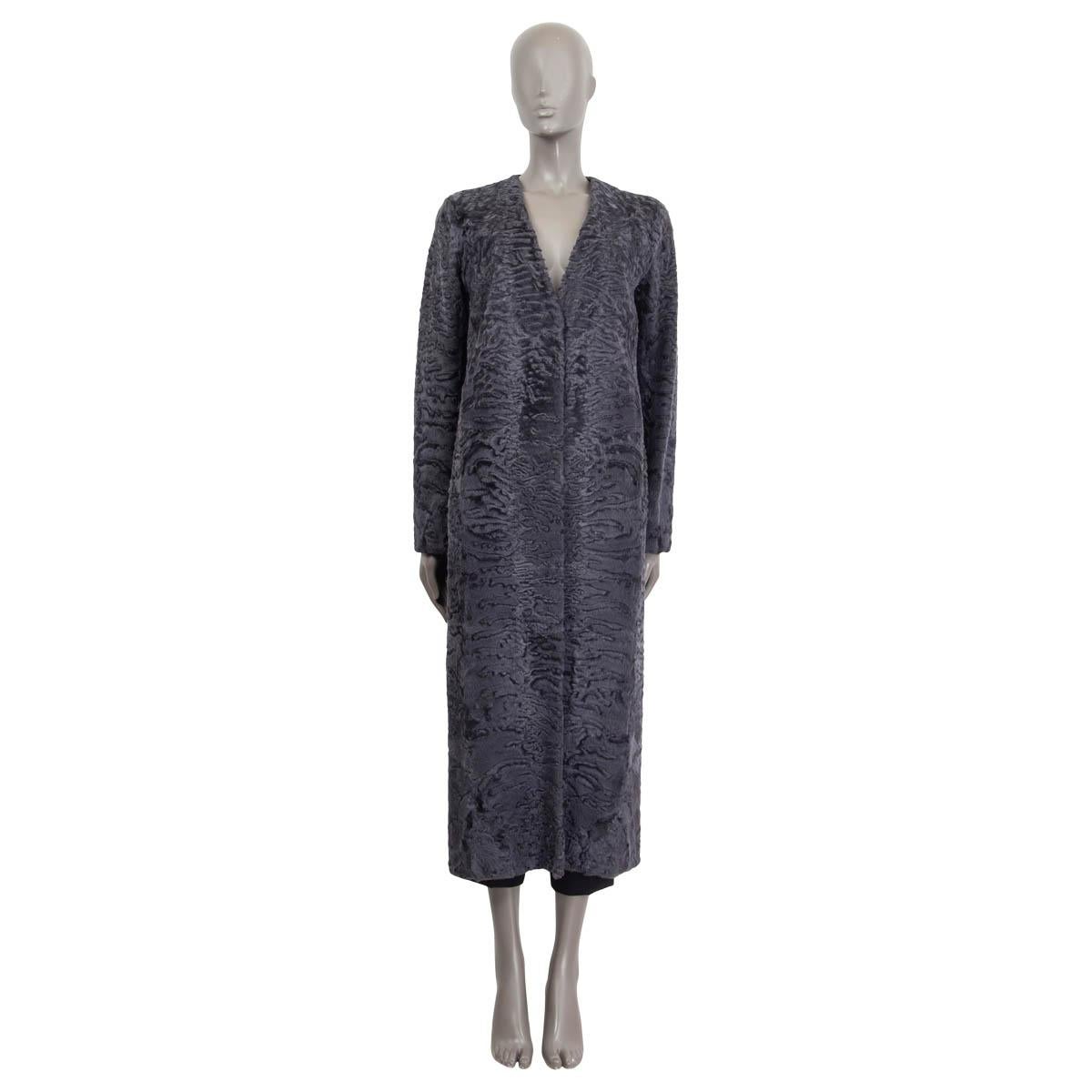 100% authentic The Row 'Denise Astrakhan' fur coat in charcoal dyed lamb fur (100%). Features a deep v-neck and a slit on the back. Opens with two hooks on the front. Lined in charcoal silk (100%). Has been worn once and is in virtually new