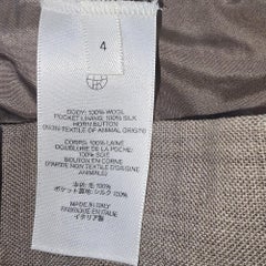 Pantaloni a zampa a vita alta di The Row in lana beige