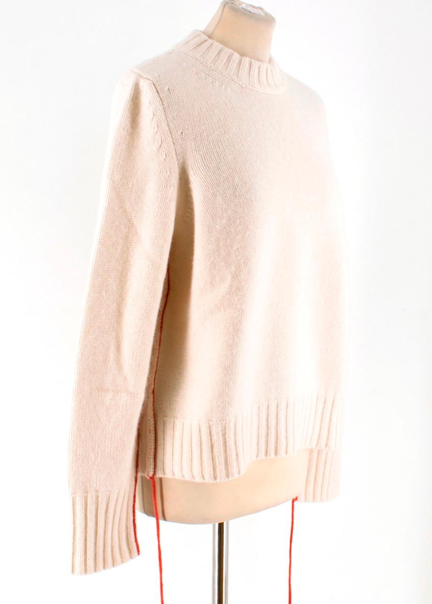 The Row Ivory Cashmere Knit With Red Trim Sweater.

- 100% Cashmere knit, Mid-weight and really soft
- High round neck
- Long sleeved
- Long single vibrant red chain edge feature
- Ribbed neck, cuffs & hem
- Loose fitting

UK 8-10 - US/6

Brand size