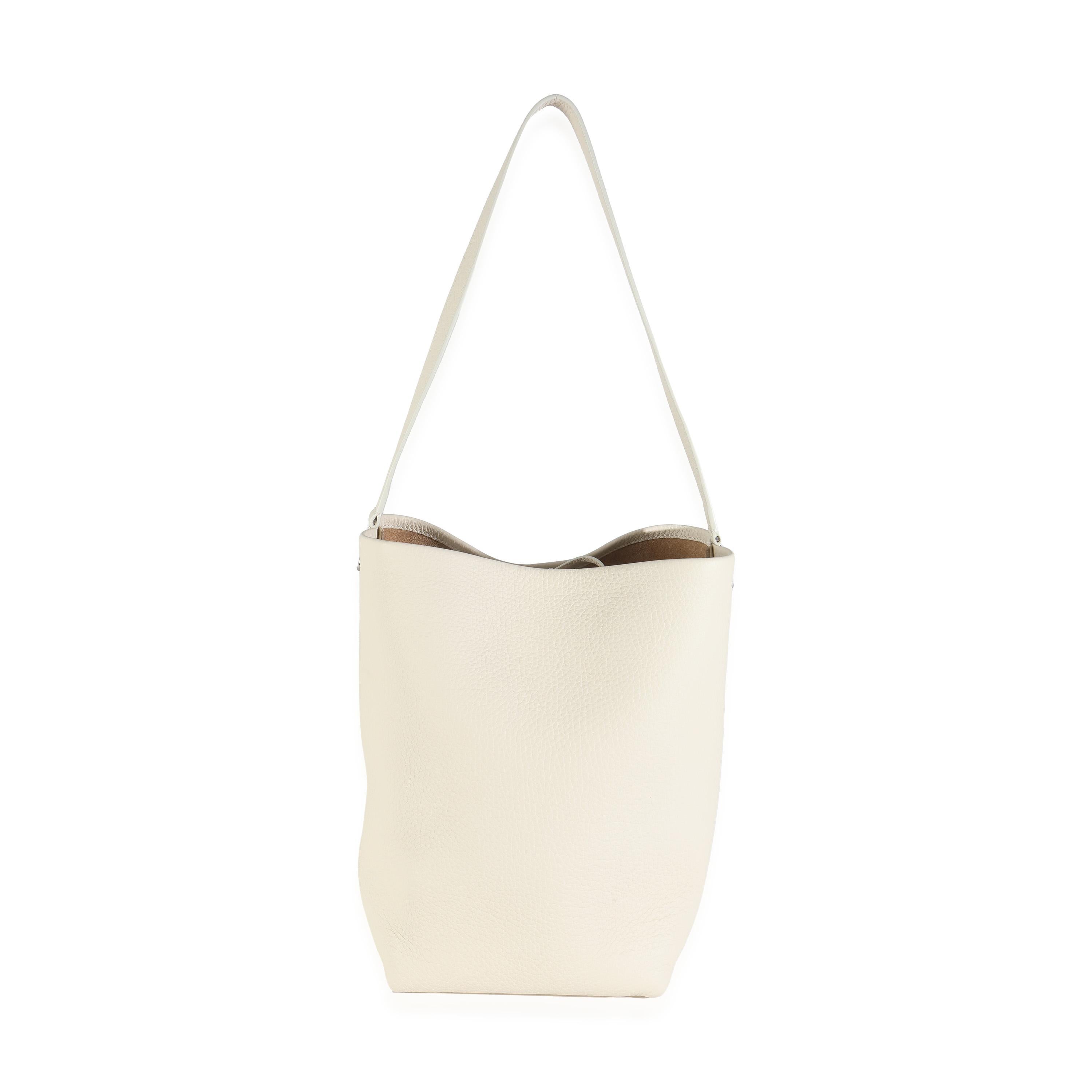 Listing Title: The Row Ivory Grained Calfskin Medium NS Tote Hook Bag
SKU: 144714
MSRP: 1950.00 USD
Condition: Pre-owned 
Handbag Condition: Pristine
Condition Comments: Item has no indication of wear.  Final sale.
Brand: The Row
Model: Medium NS