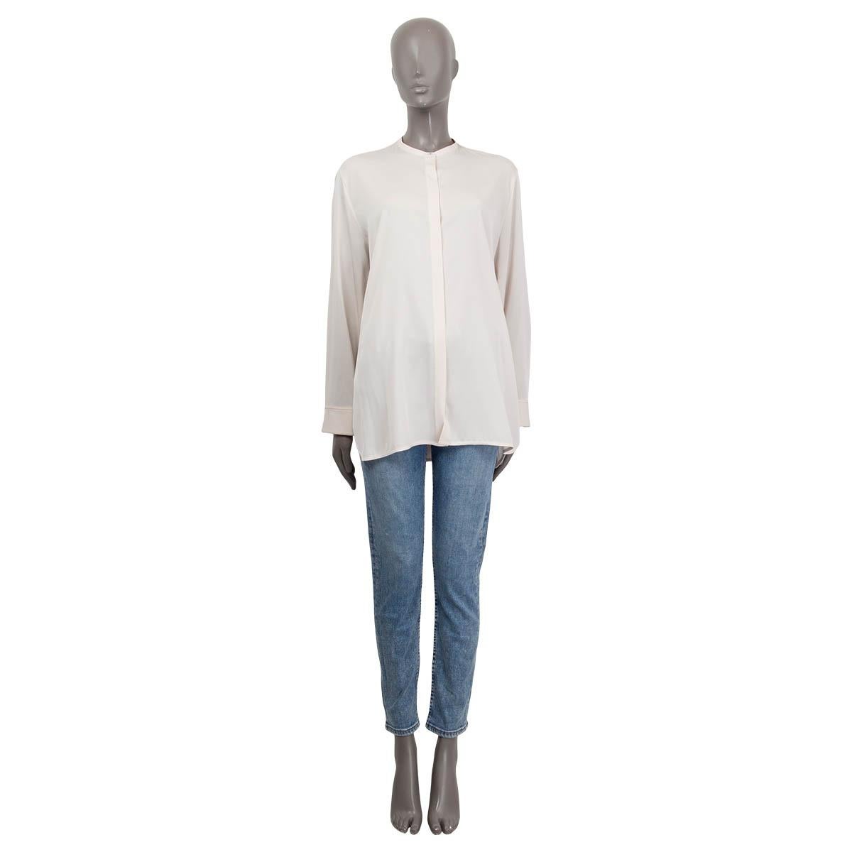 100% authentic The Row long sleeve oversized shirt in ivory silk (93%) and elastane (7%). Features buttoned cuffs and a eggplant hem sticht at the cuffs. Opens with eight shell buttons. Brand new, with tags. 

Measurements
Tag Size	M
Size	M
Shoulder