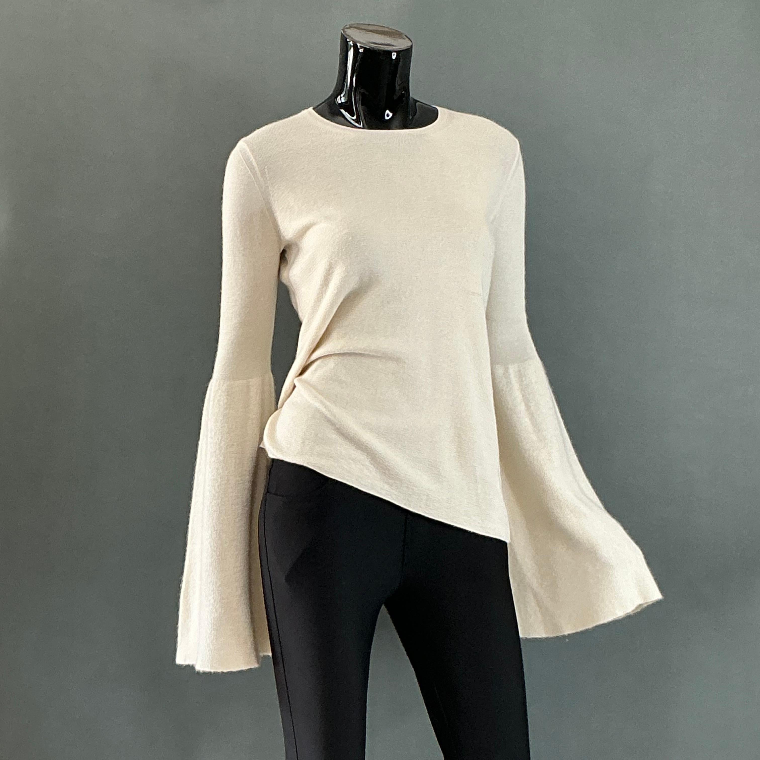 The Row Vintage Cashmere Bat Wing Knit Top would likely be a luxurious, minimalist piece that exemplifies the brand’s signature understated elegance and timeless quality. The Row, known for its focus on craftsmanship and premium materials, has built