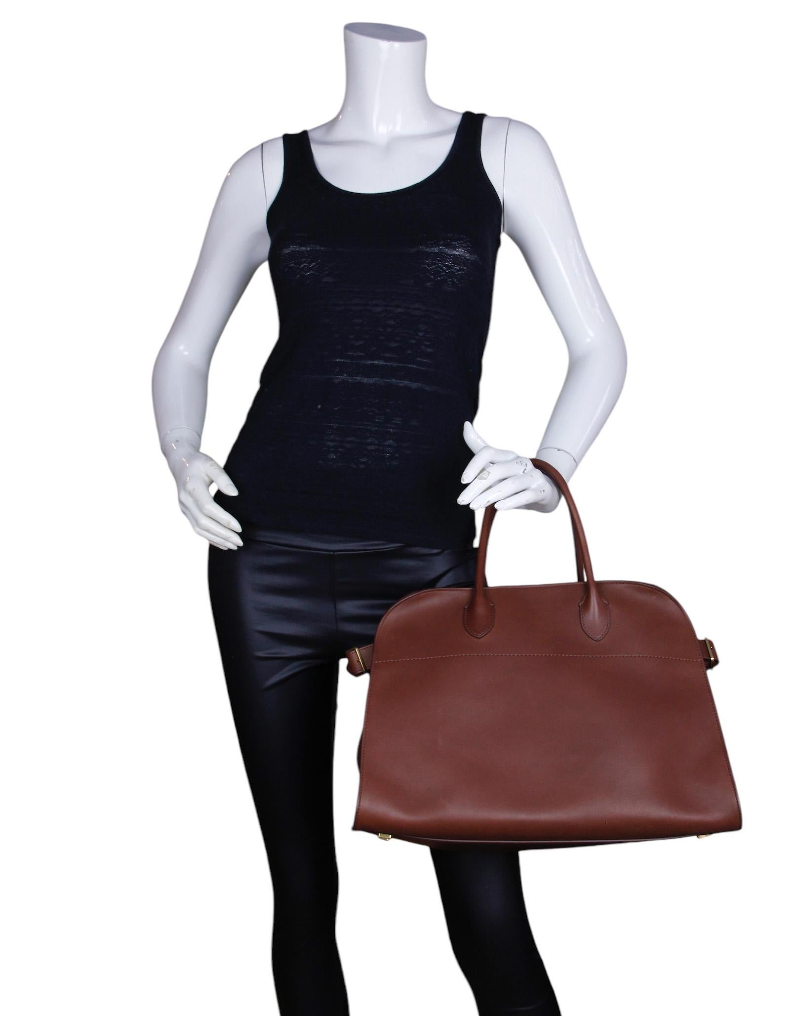 The Row New Burgundy Leather Soft Margaux 15 Tote Bag

Made In: Italy
Color: New burgundy 
Hardware: Silvertone
Materials: Leather
Lining: Canvas
Closure/Opening: Open with side buckles
Exterior Pockets: None
Interior Pockets:  One zip pocket, two