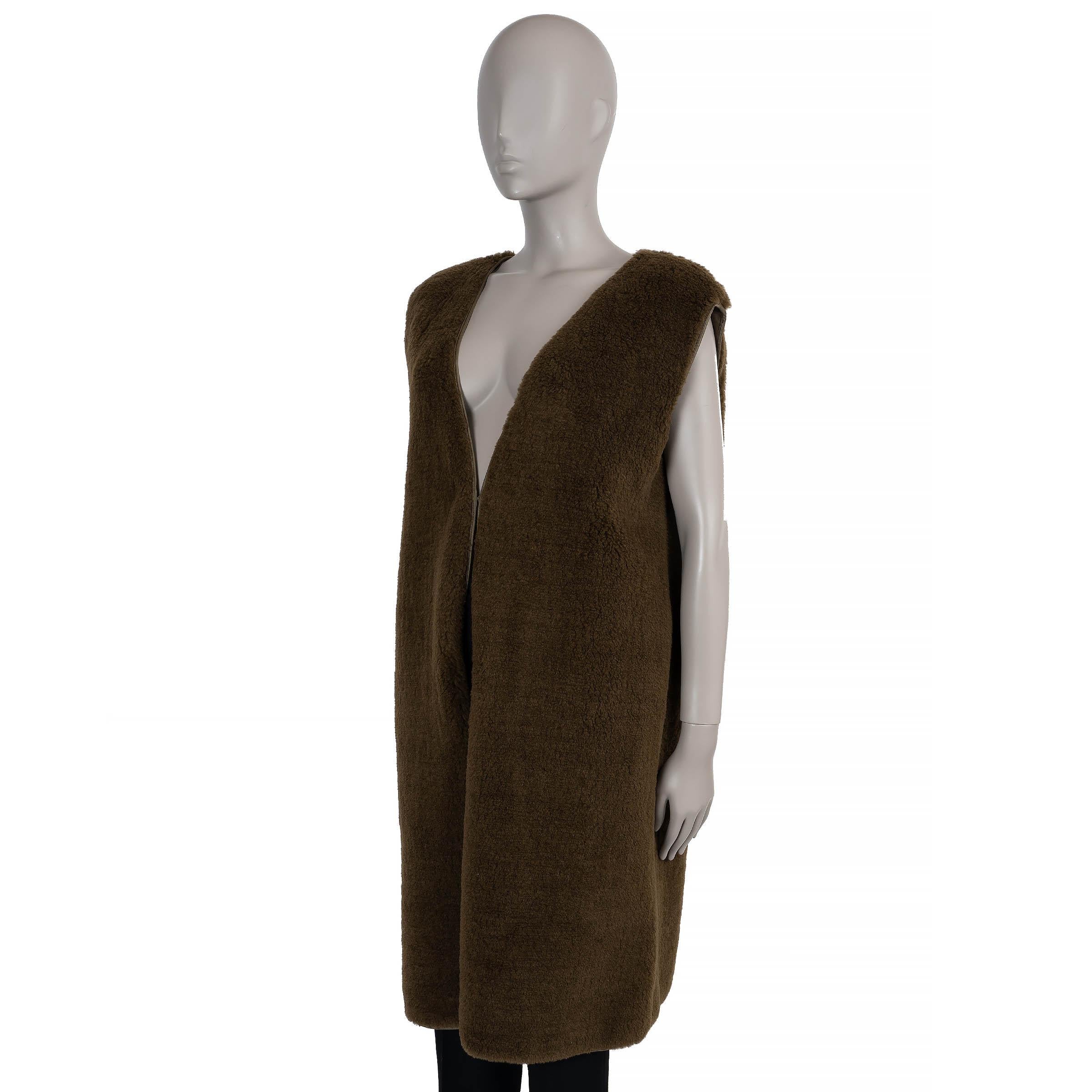 This 100% authentic The Row Beyzita vest in olive teddy camel hair and silk blends luxurious texture with minimalist elegance. Designed with a relaxed, longline silhouette, it features a V-neck and discreet side slit pockets. Opening with front