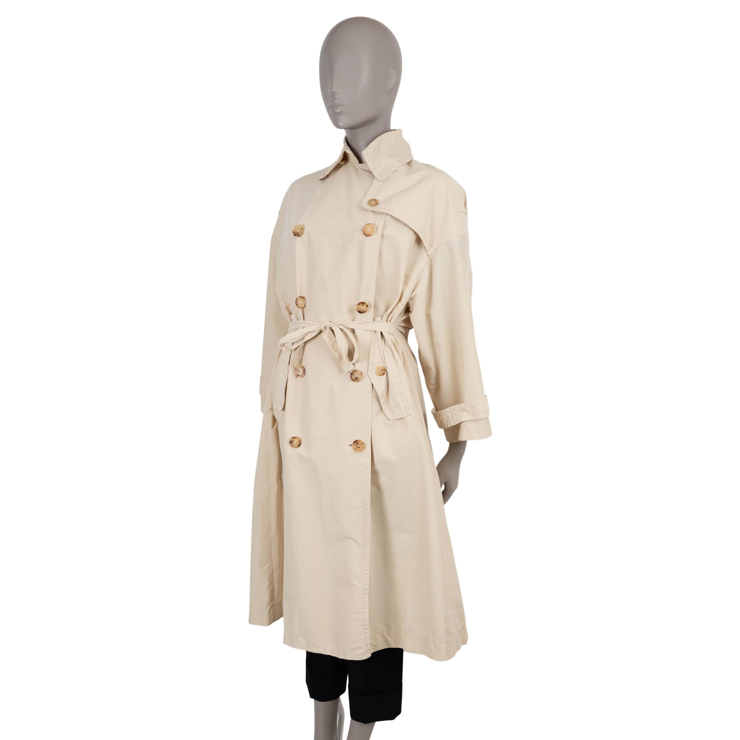 This 100% authentic The Row trench coat is crafted in pale beige faille silk (please note the content tag is missing), offering a fluid drape with a structured yet airy finish. The oversized silhouette cinches at the waist with a matching belt and