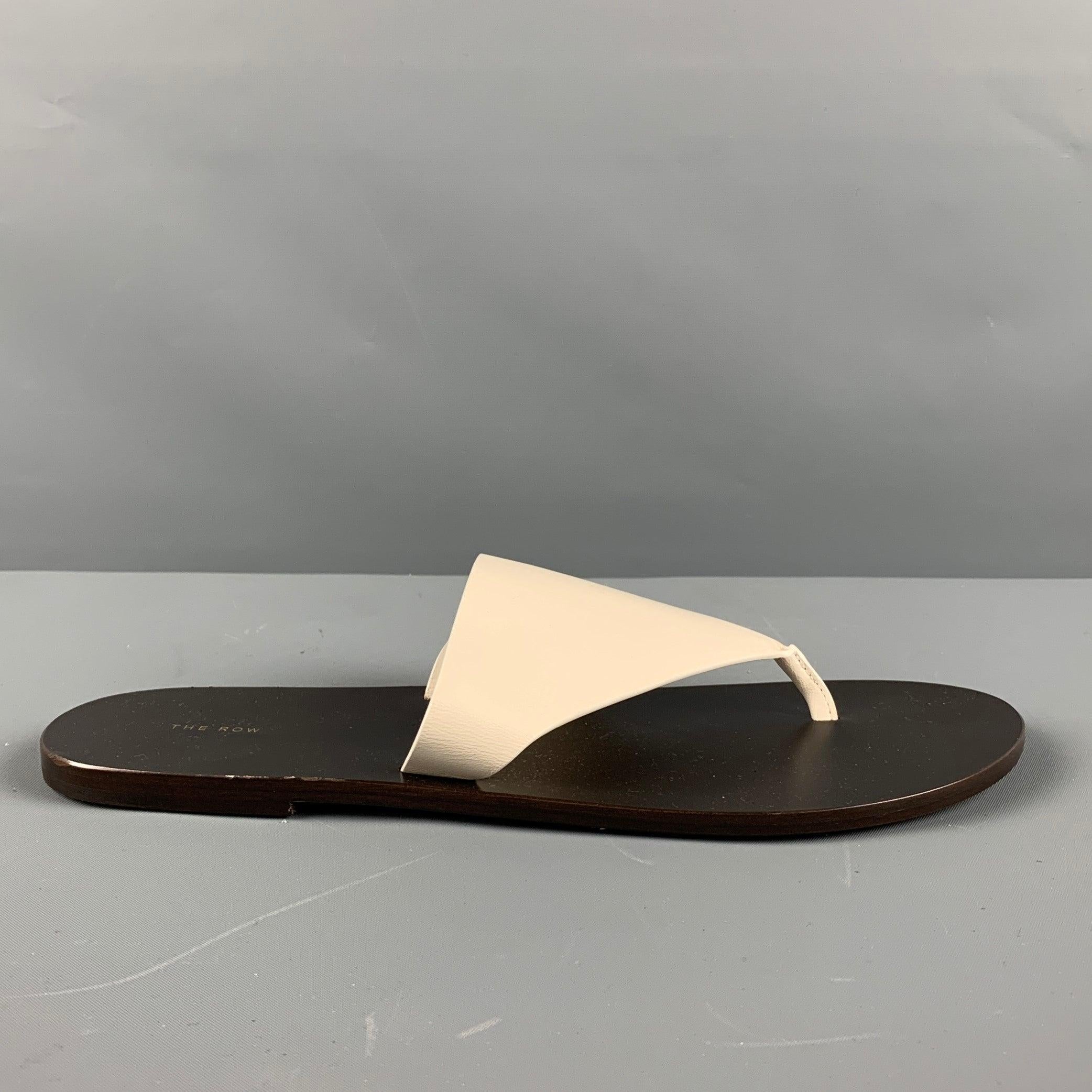 THE ROW AVERY sandals comes in a cream leather featuring a brown leather sole and a thong style. Made in Italy.Excellent Pre- Owned Condition. 

Marked:   37 1/2Outsole: 10 inches  x 3.75 inches  
  
  
 
Sui Generis Reference: 129475
Category: