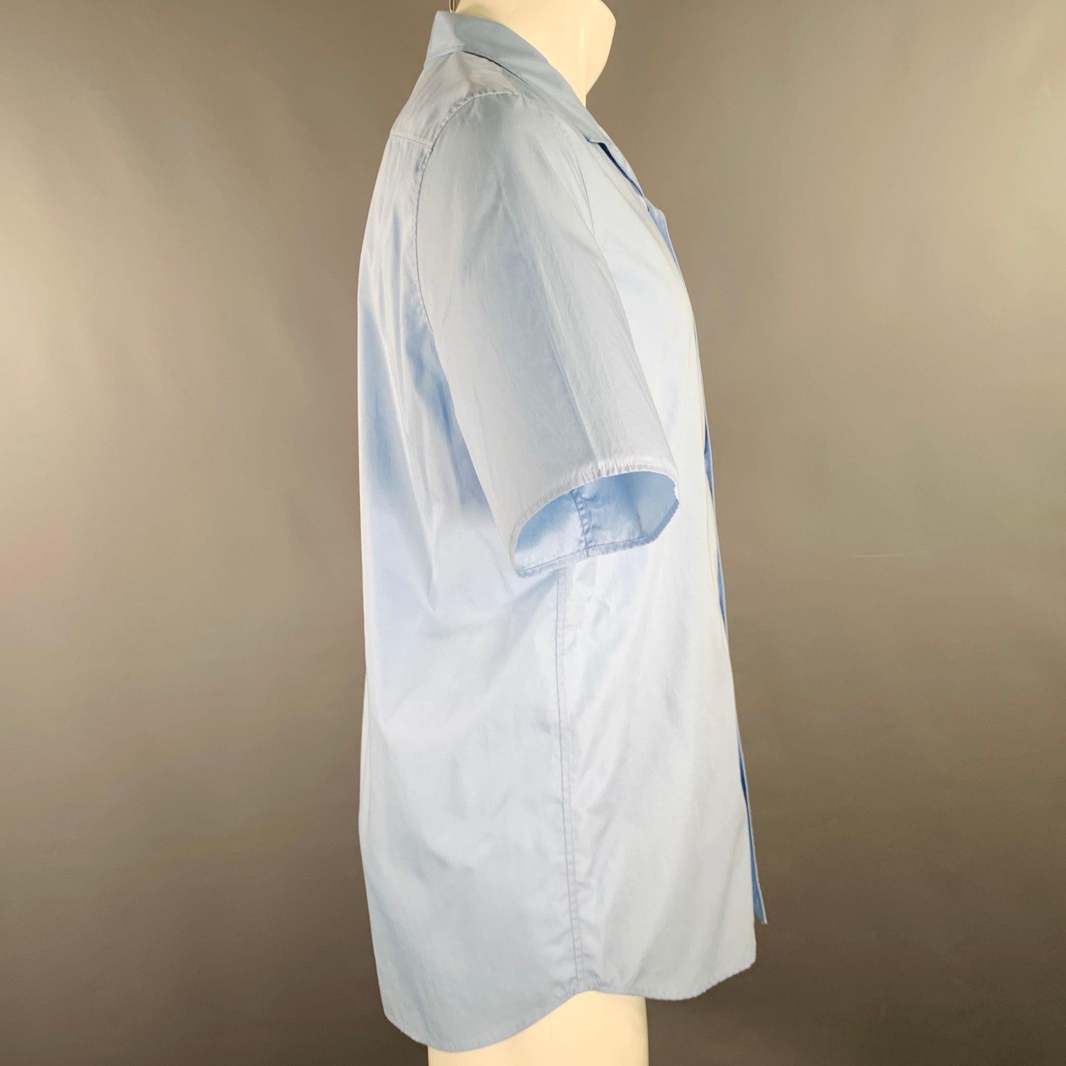 THE ROW short sleeve shirt
in a blue cotton woven fabric featuring a camp style, and button closure. Made in Italy.Excellent Pre-Owned Condition. 

Marked:   S 

Measurements: 
 
Shoulder: 16 inches Chest: 38 inches Sleeve: 11 inches Length: 30.5