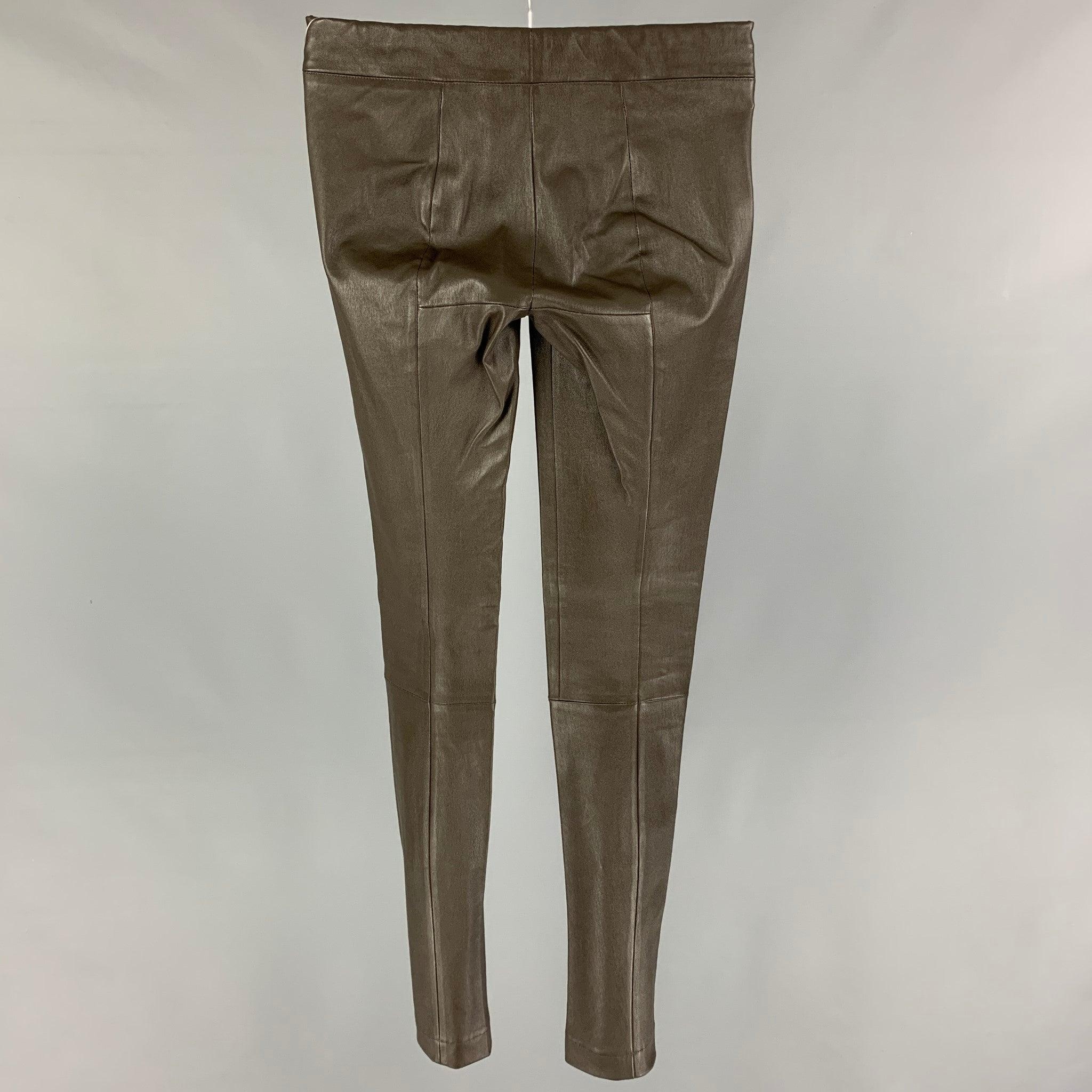 THE ROW leggings comes in a green olive lamb skin leather featuring a elastic waistband.Excellent
Pre-Owned Condition. 

Marked:   XS 

Measurements: 
  Waist: 22 inches Rise: 8 inches Inseam:
32 inches Leg Opening: 10 inches 
  
  
 
Reference:
