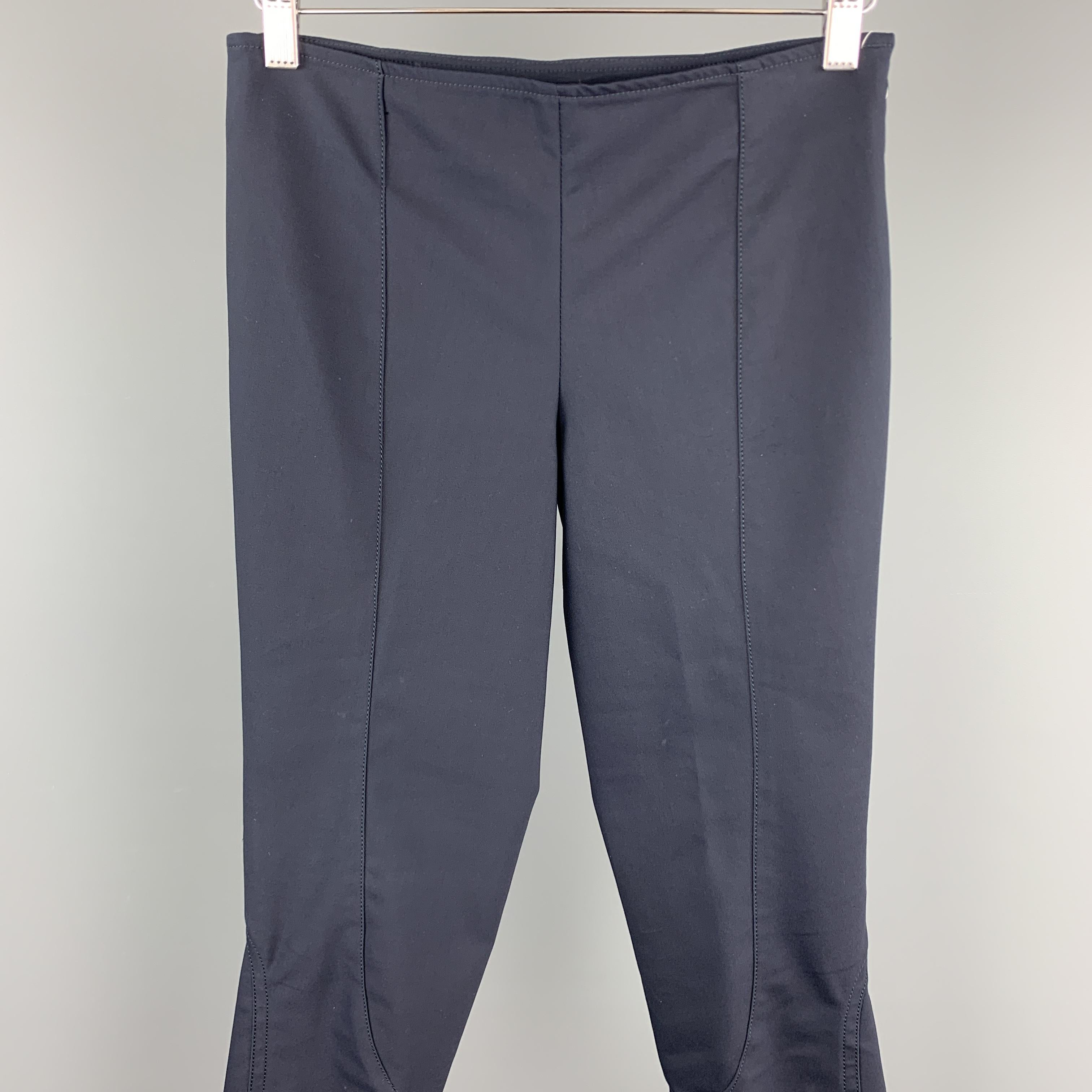 THE ROW dress pants come in a stretch navy fabric with a slim fit, zip cuff, and riding style seam details. Made in USA.

Excellent Pre-Owned Condition.
Marked: XS

Measurements:

Waist: 28 in.
Rise: 11 in.
Inseam: 28 in. 