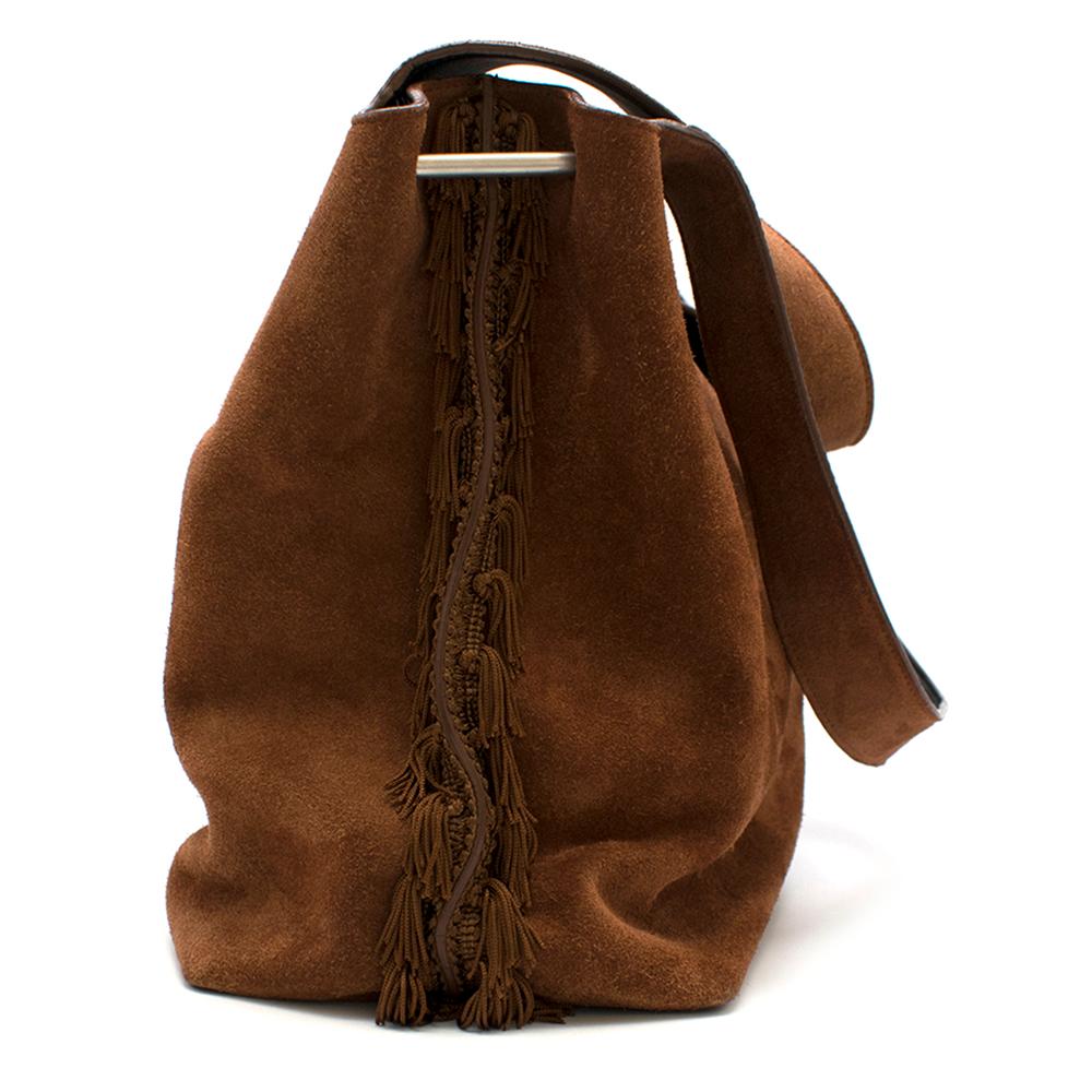 The Row suede duplex hobo with two flat shoulder straps, fringe embellishments along the sides with metal bar accents, tonal suede and black leather lining, three interior compartments; mid with top zip closure and magnetic closure at the