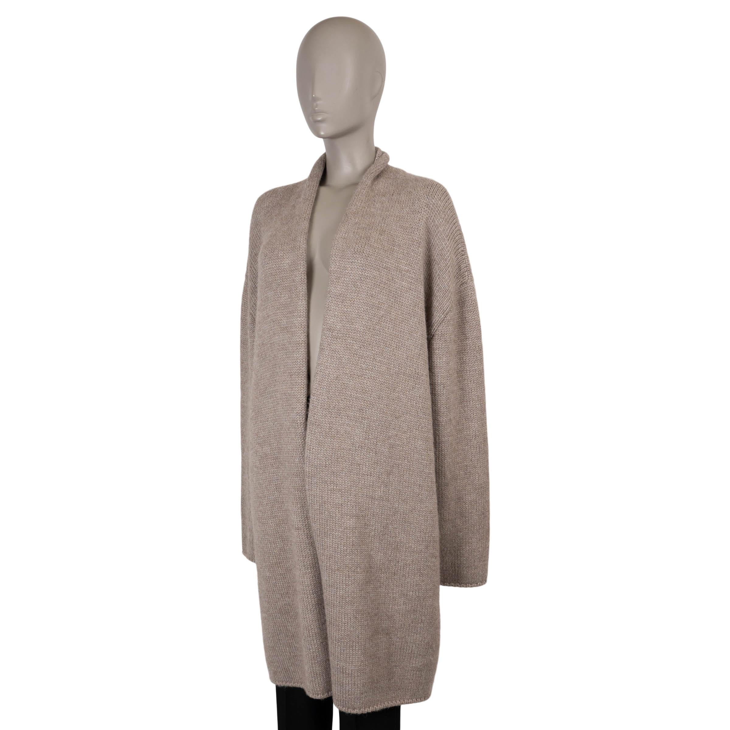 This 100% authentic The Row Ernesto knit coat is crafted in light taupe alpaca (80%) and silk (20%) for an exceptionally soft and lightweight hand. Designed in the brand’s signature minimalist aesthetic, it features a cocoon silhouette with dropped