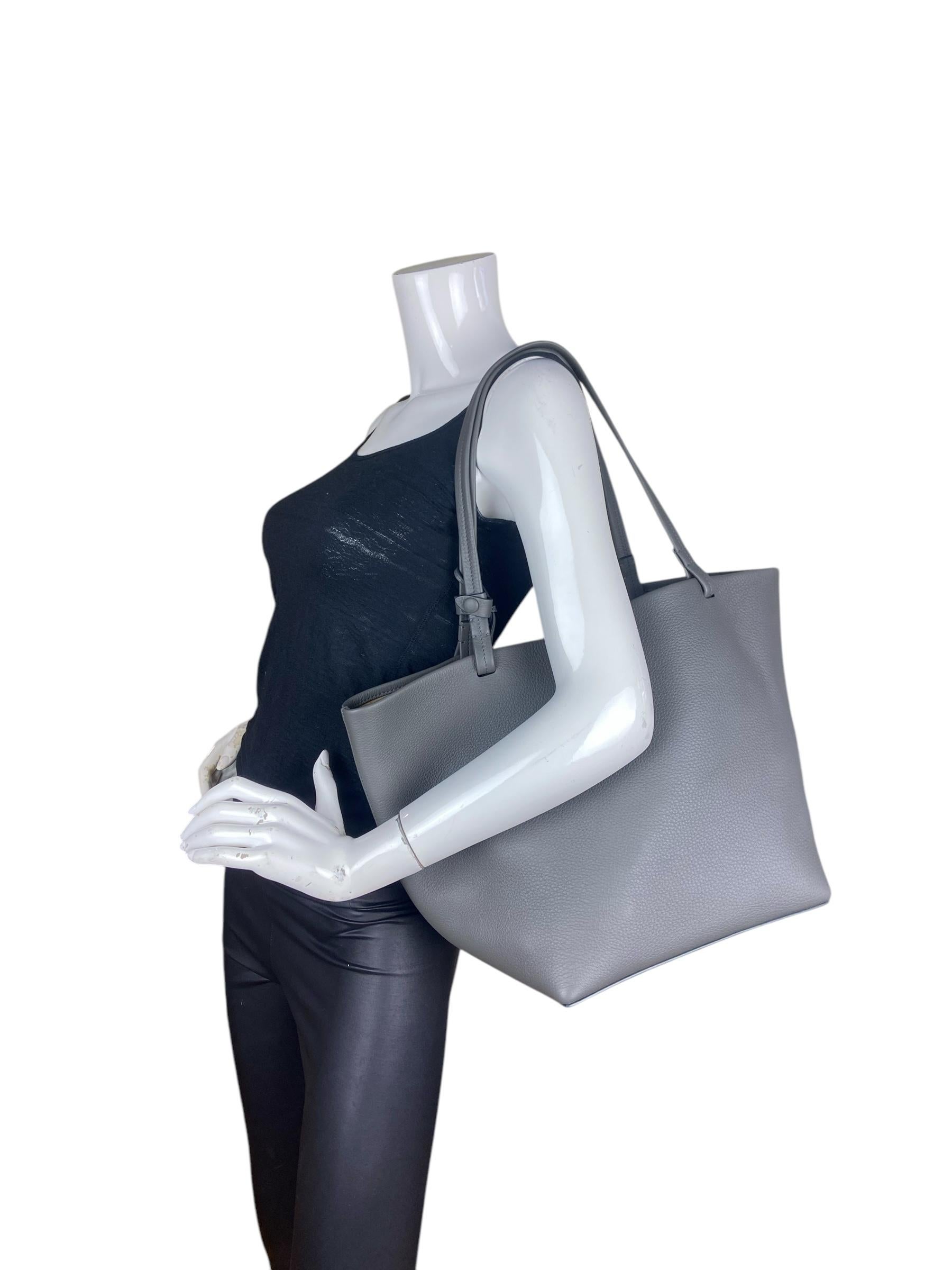 The Row Timouse Grey Grained Calfskin Leather Park Tote Three Bag with Insert

Made In: Italy
Color: Timouse Grey 
Hardware: None
Materials: Calfskin leather
Lining: Suede
Closure/Opening: Open with leather center tie
Exterior Pockets: None
Interior