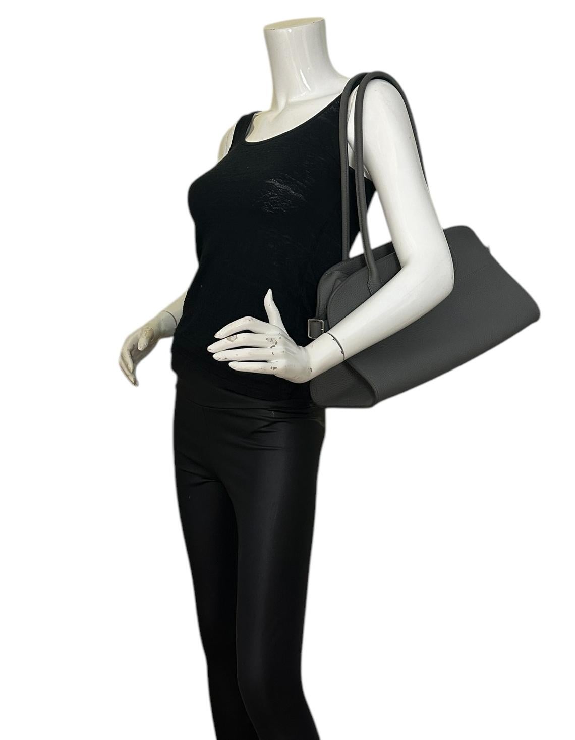 The Row Timouse Grey Leather E/W Soft Margaux 12 Bag

Made In: Italy
Color: Timouse Grey
Hardware: Silvertone
Materials: Grained leather
Lining: Canvas
Closure/Opening: Open with side buckles
Exterior Pockets: None
Interior Pockets:  One zip pocket,