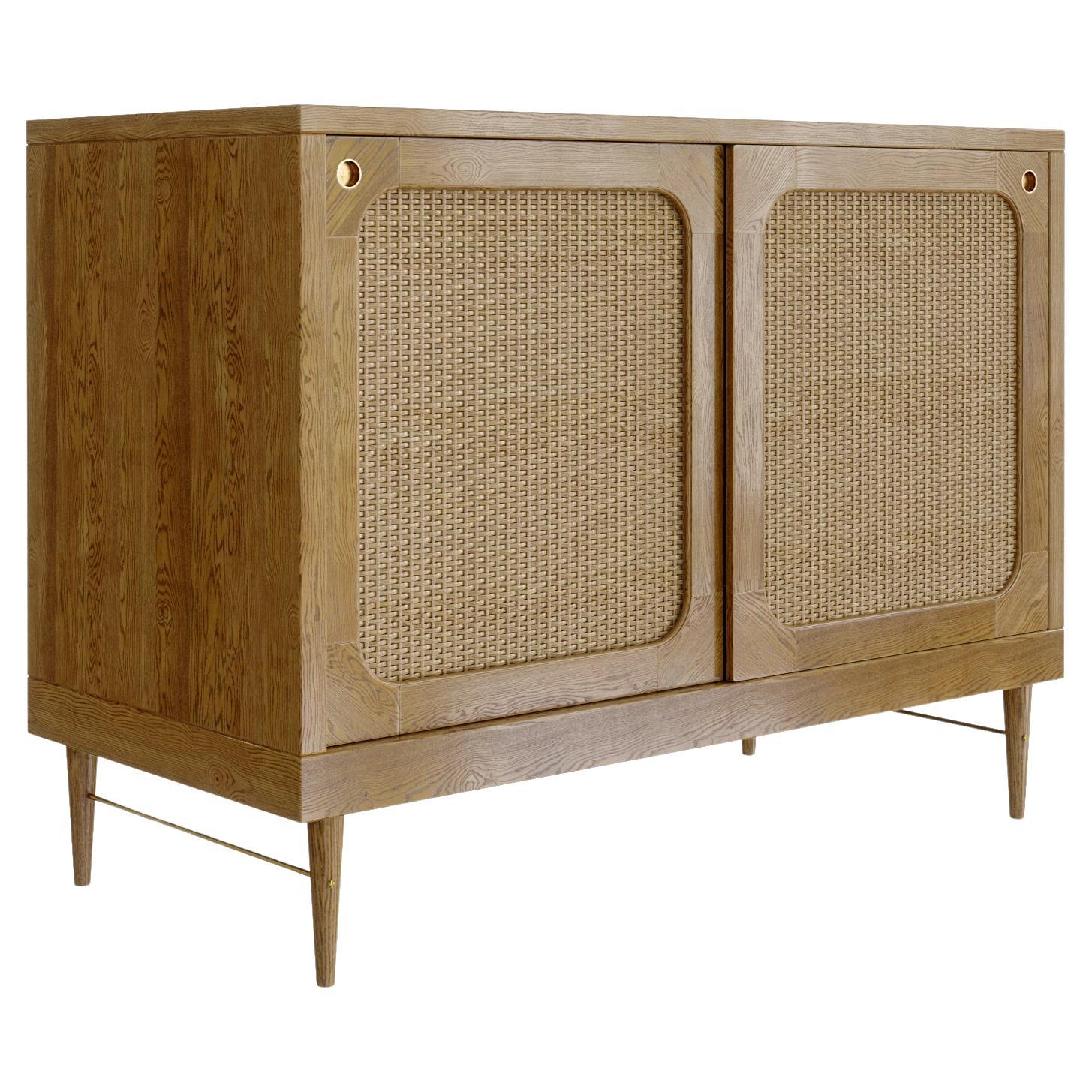 A sideboard in European oak and rattan, developed by Lind + Almond especially for Sanders, Copenhagen's premier luxury boutique hotel.

Available in two timber tones, Cognac and Natural Oak. Handcrafted to order in Europe. Internally there are two