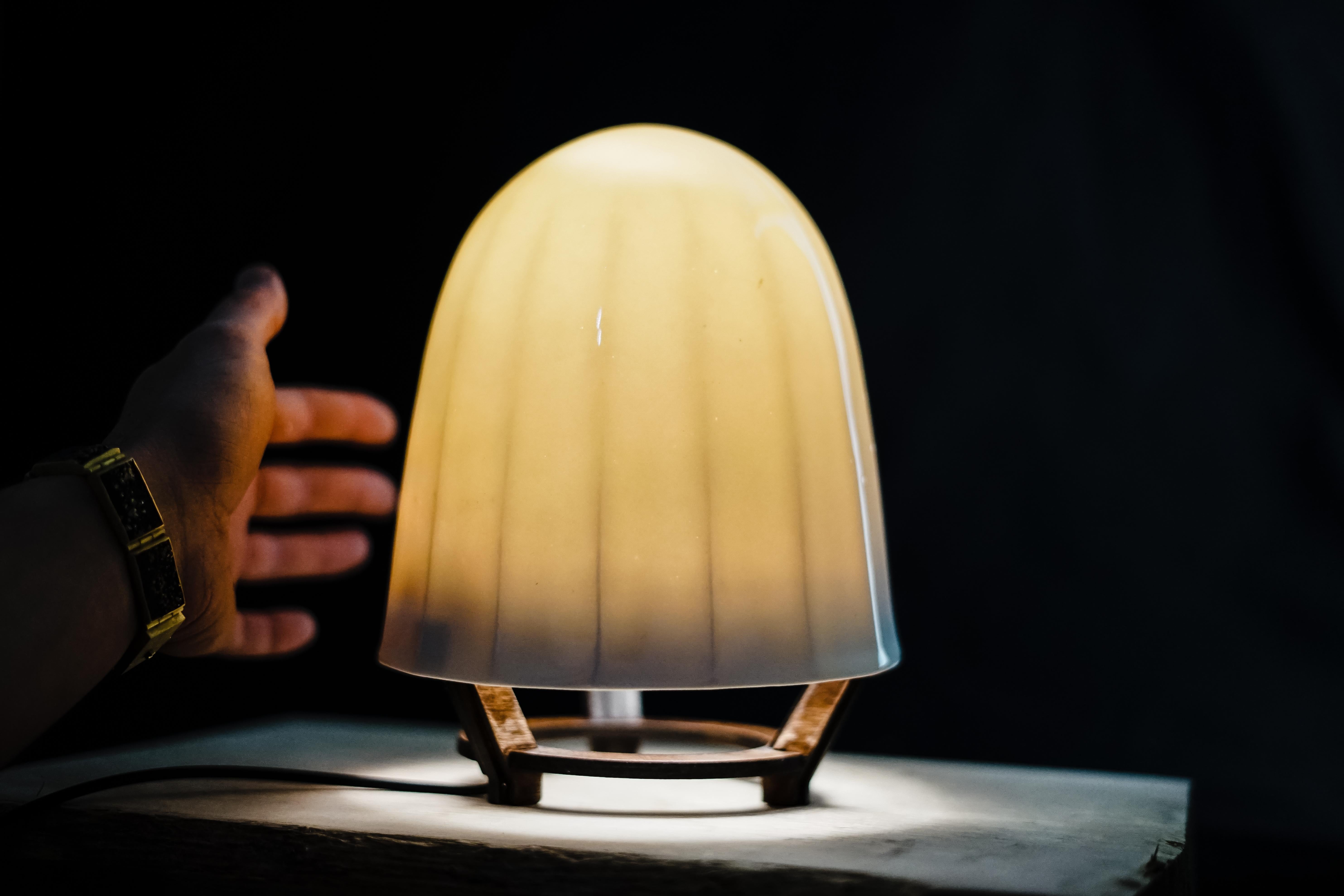 This unique translucent porcelain lamp uses capacitive-sense technology to sense your electromagnetic field and turn on and off when you hover your hand near the lower part of the shade. 

- Perfect ambient glow for bedside table lamp, yoga