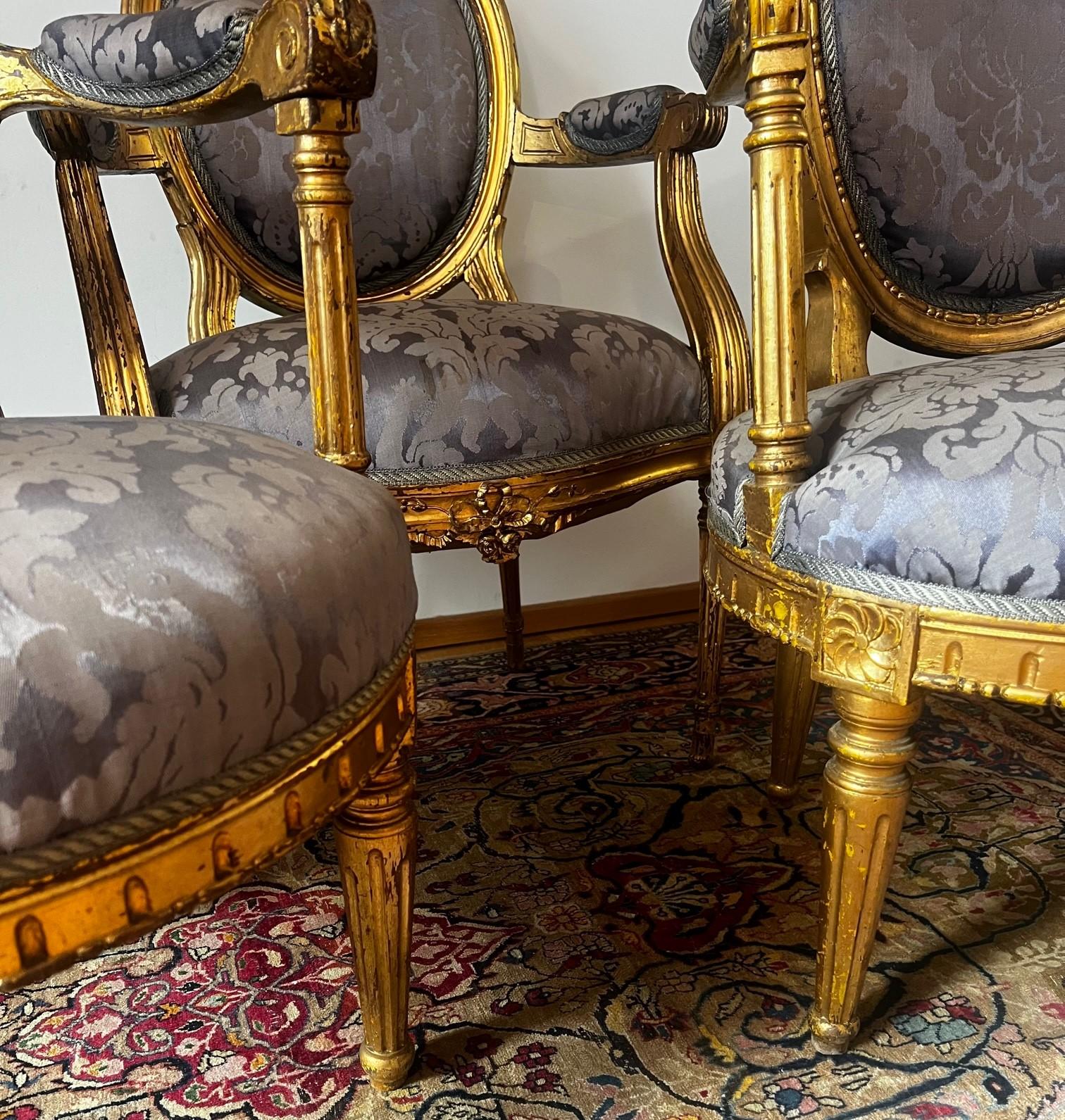 This magnificent set of three French antique Louis XVI (ca 1770) gold gilded armchairs originated from the region of Avignon. These stunning original armchairs are elegant and characterising an epoch –most of the furniture of this time was made for