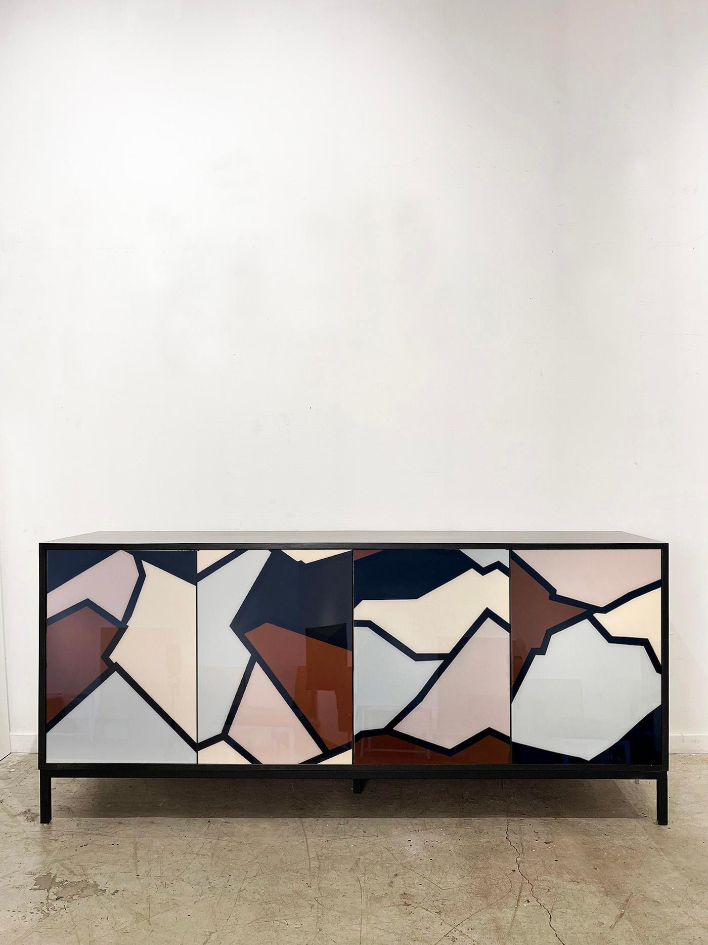 The Shard Cabinet by Morgan Clayhall is a bold fusion of fine art and functional design. Inspired by natural rock strata and the raw geometry of fractured forms, this piece channels layered landscapes into a dynamic abstract composition.

Each