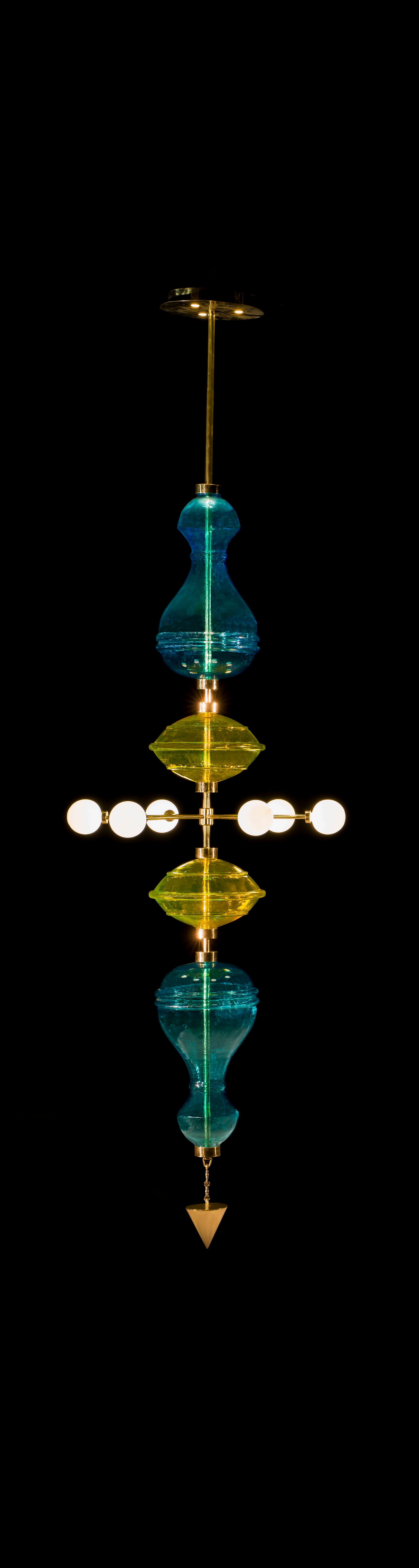 La lampada a sospensione Shikhara si ispira alle proporzioni dei templi indiani. Rappresenta il sistema dei cinque elementi o Panchamahabhuta Bhumi (Terra), Jala (Acqua), Agni (Fuoco), Vayu (Aria o Vento), Akash (Etere) in quanto ogni Forma