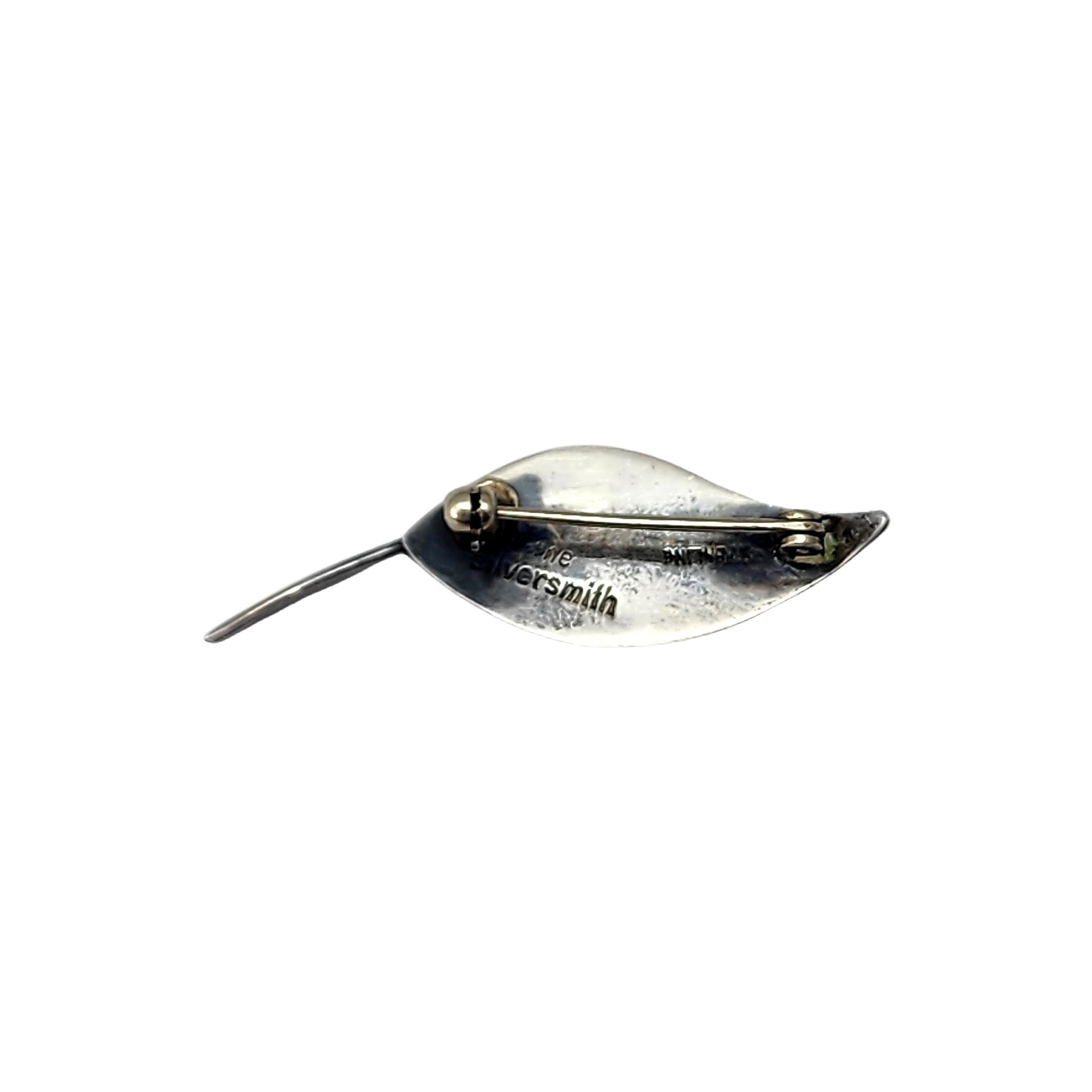 Vintage modernist sterling silver leaf pin/brooch by The Silversmith.

Ella L Cone was the proprietor of The Silversmith's Shop in Boston and Hyannis in the 1940s thru the 1960s. This small piece features modernist lines with an applied center