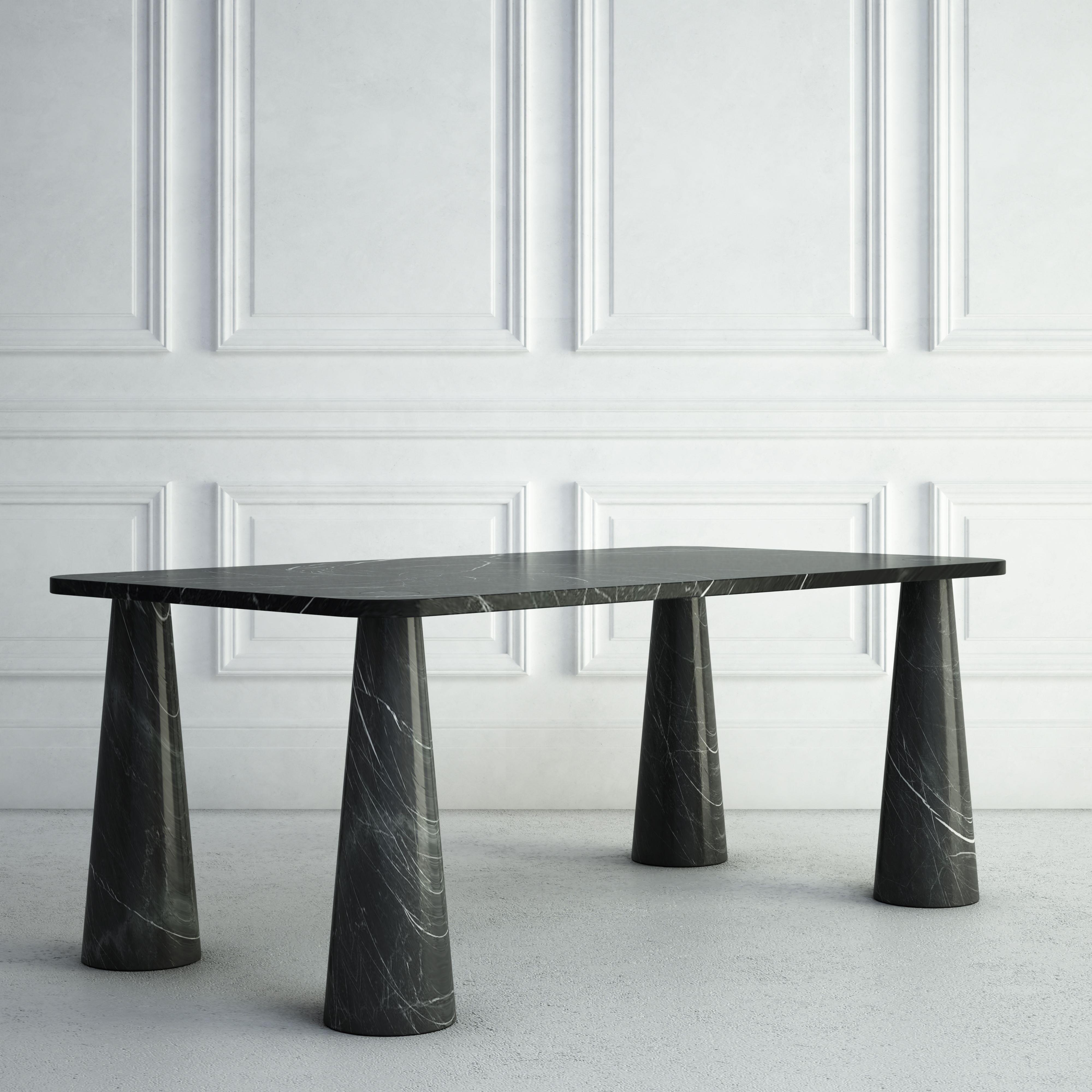 The Simone is a whimsical modern dining table.  The top is made from an elegant thin rectangular stone slab.  Each of the four legs is positioned directly below a corner of the top.  The legs are rounded, but taper in as they reach the top, giving
