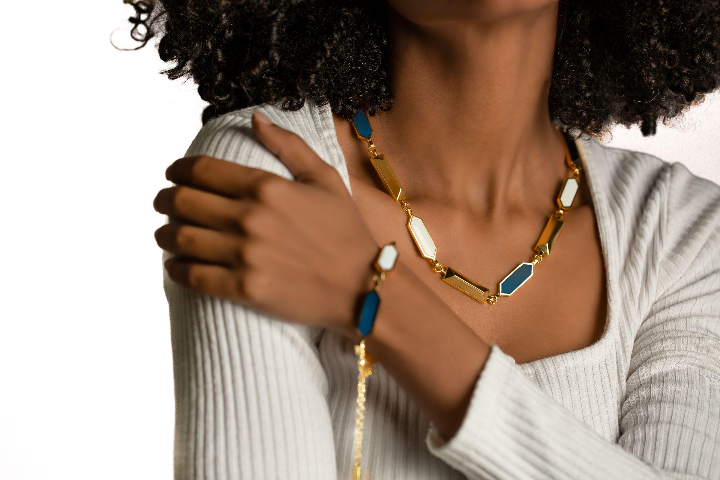 This intricately crafted necklace is meticulously fashioned from exquisite golden and translucent azure blue enamel, showcasing a harmonious blend of opulence and elegance. This remarkable jewelry exemplifies the pinnacle of artisanal craftsmanship,