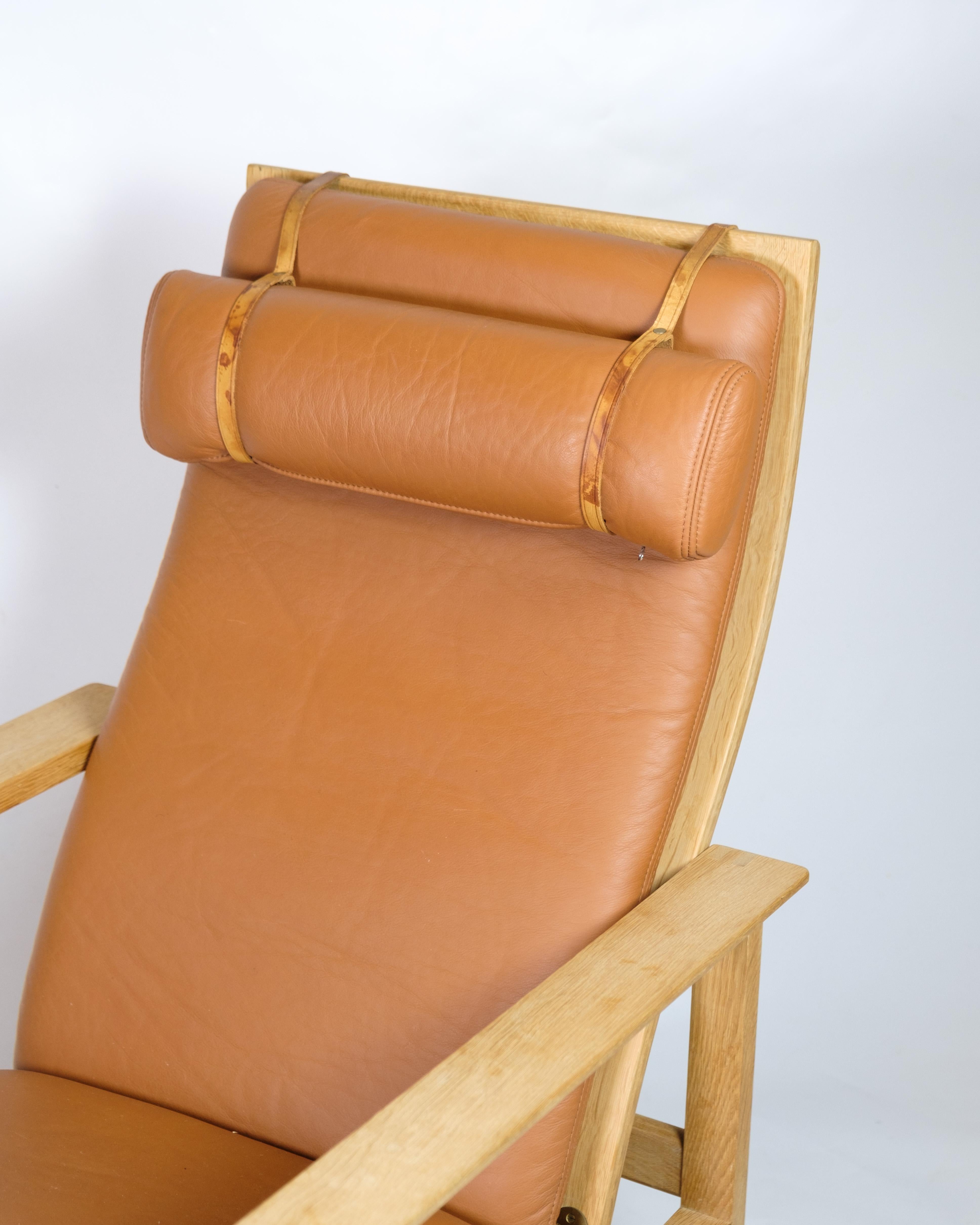 The sled chair, model BM2254, designed by Børge Mogensen and manufactured by Fredericia Stolefabrik. The chair is made of light oak with a seat and backrest upholstered in cognac-colored Elegance leather, which gives a warm and classic look. The
