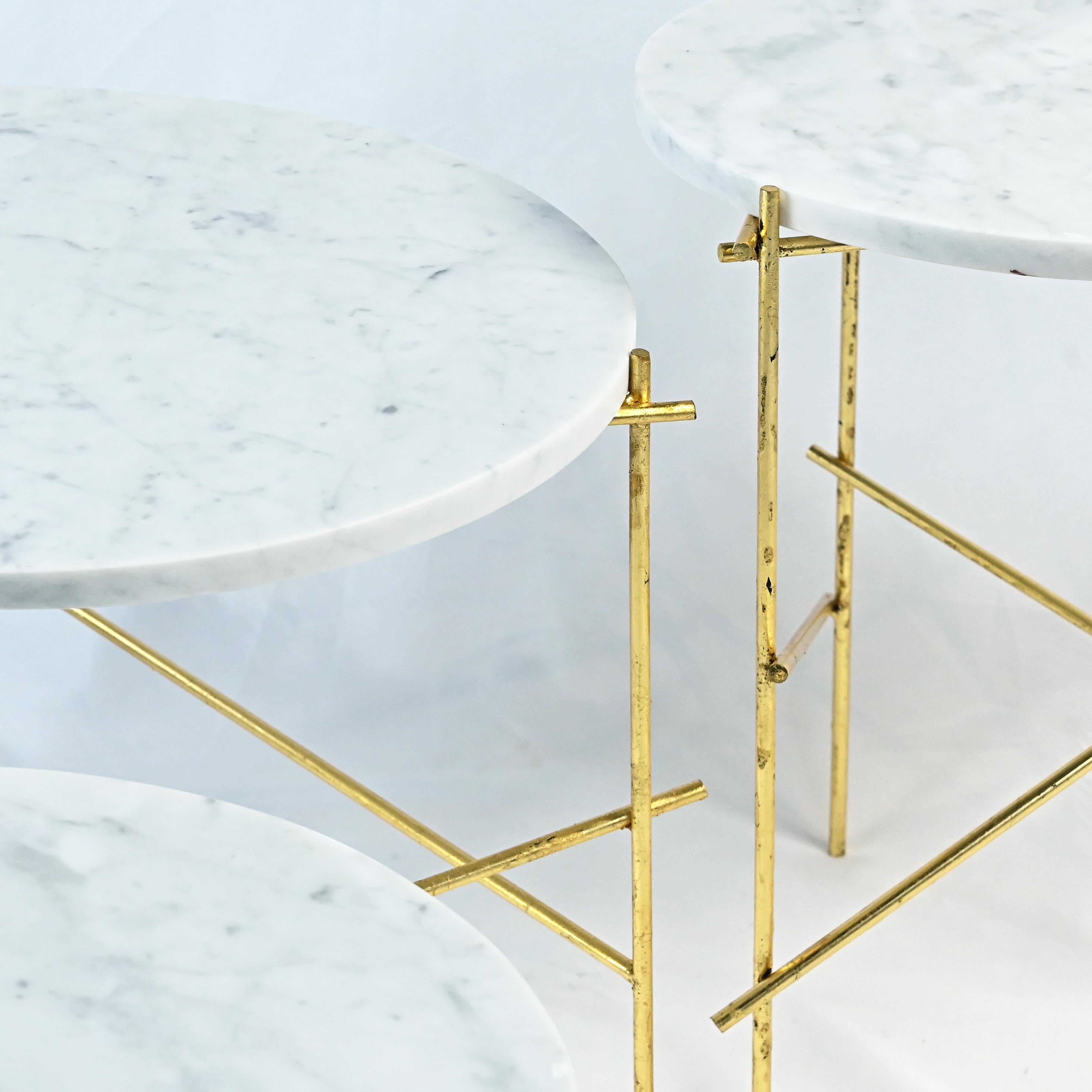 The Stilts coffee table collection is created through the combination of Carrara Marble tops and steel legs, which are finished with a golden leaf application.
The golden leaf application is purposely refined with a scratched effect, and works in