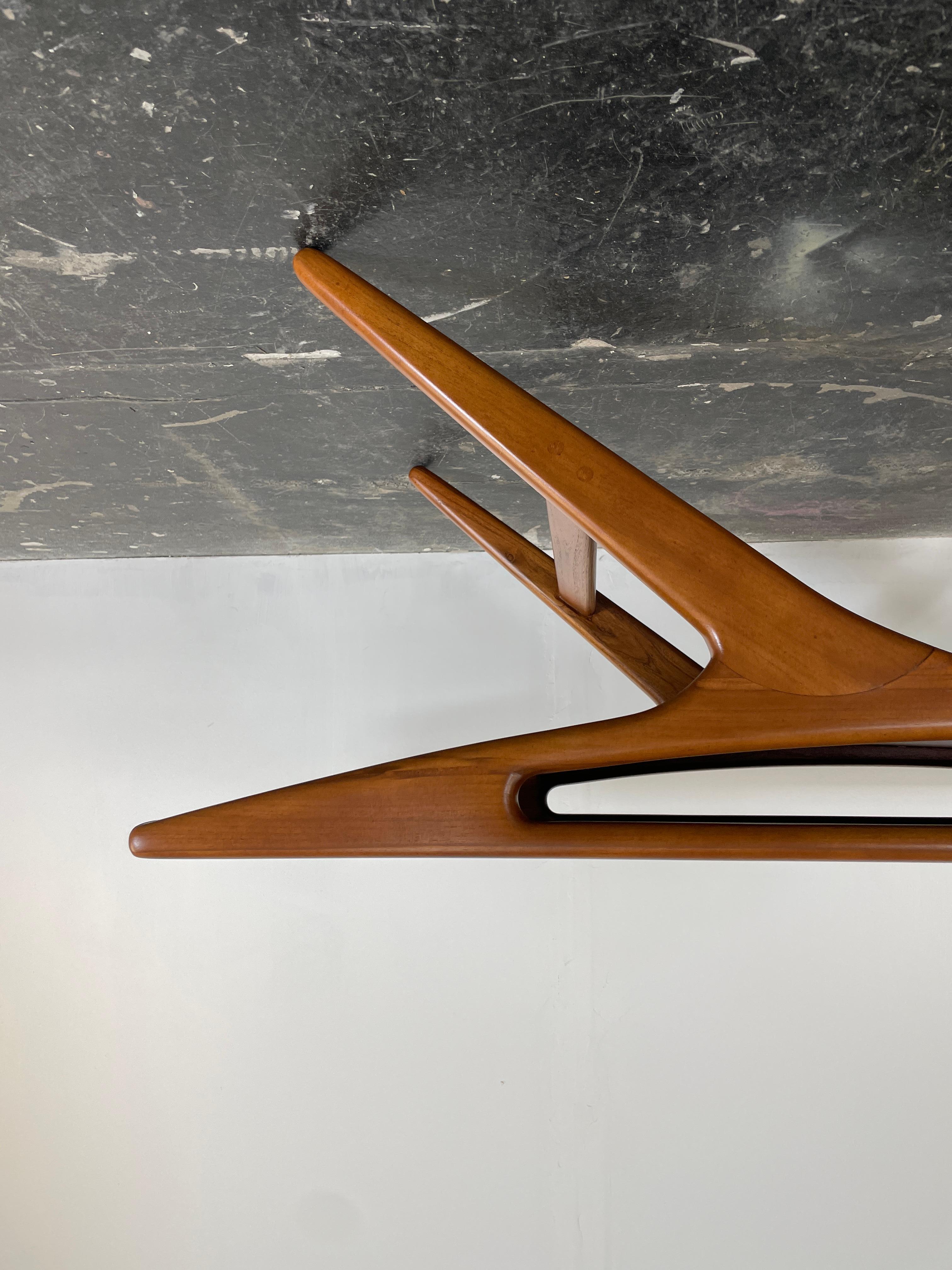 This iconic Smile Coffee Table designed by Johannes Andersen is a much sought after for collectors and lovers of design. It is beautifully constructed of teak. The Mid Century Modern coffee table boasts beautifully splayed legs and an integrated