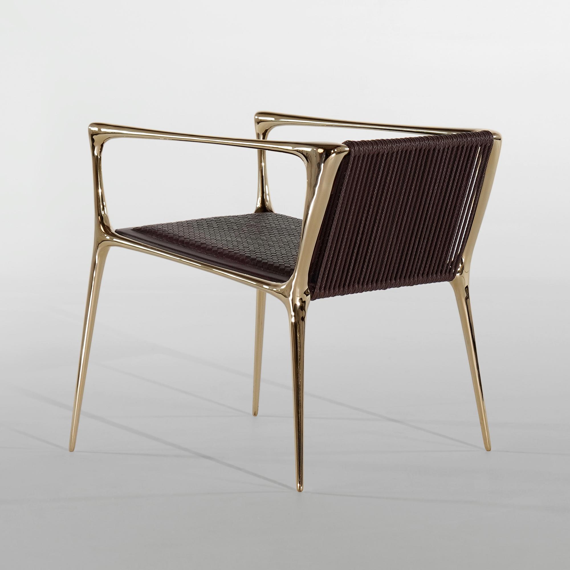 
The Sophiel Chair features a graceful bronze frame, complete with woven leather upholstery. The Sophiel effortlessly charms with its juxtaposed nature, starting from its woven leather upholstery and finally complemented by a smooth polished bronze