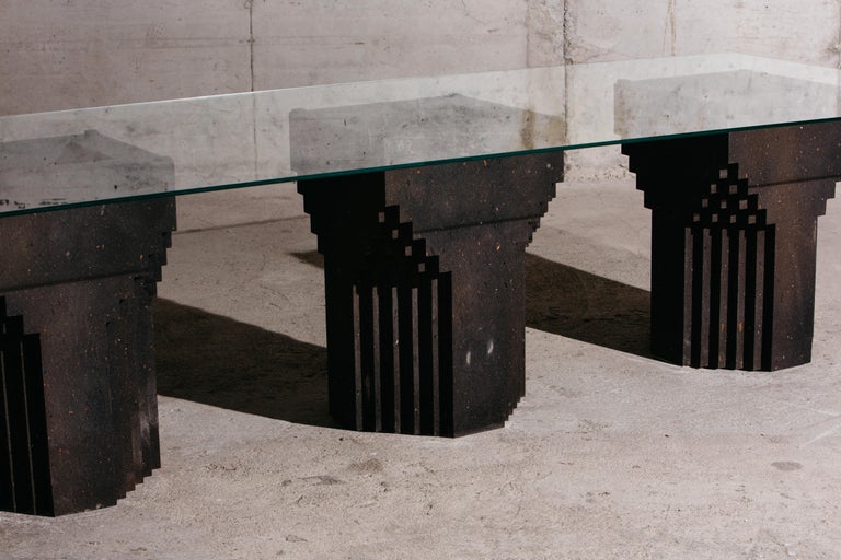The source dining table no.1 features three bases, each handcrafted from black tuff and a glass tabletop. It is a limited edition of 10, and comes with a “Certificate of Authenticity”.

The source is a collection of sculptural interior objects