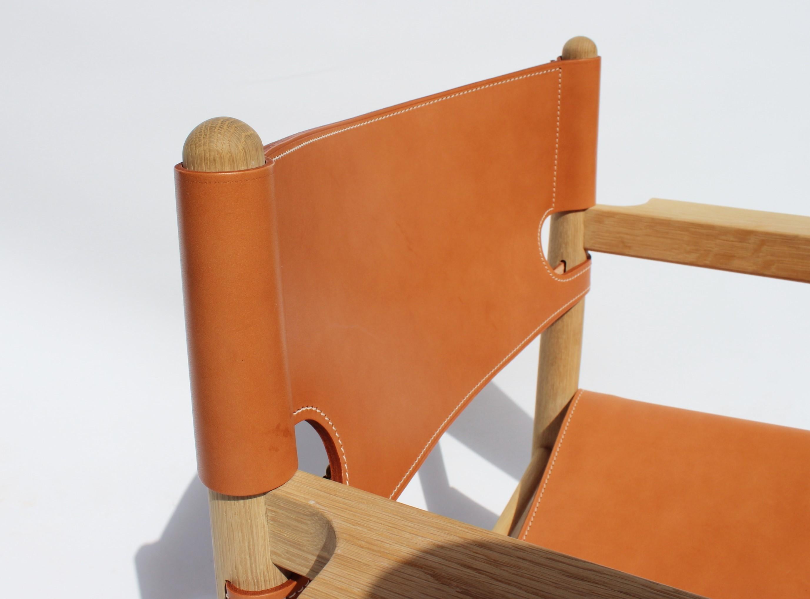 The Spanish dining chair with armrests, model 3238, designed by Børge Mogensen and manufactured by Fredericia Furniture in 2019. The chair is of oak and cognac leather.