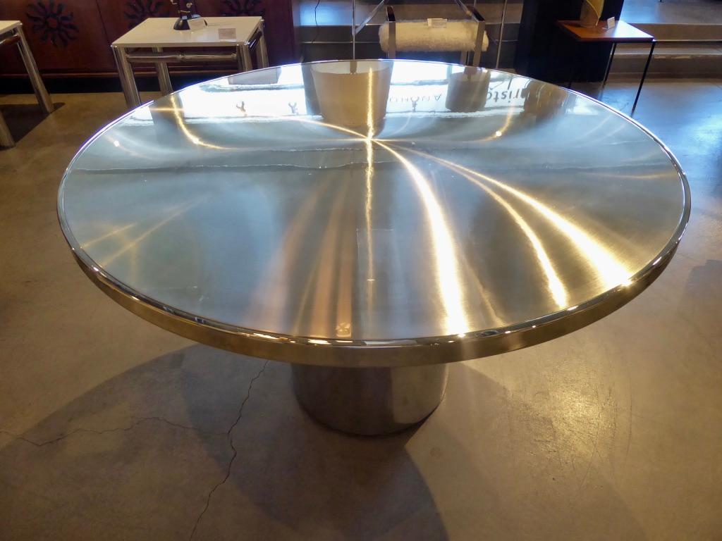 The speer table was a Brueton Classic, fabricated entirely in stainless steel. The combination of polished stainless steel base with a circular spun-brushed stainless steel top surface is uniquely and exquisitely accomplished. The base and apron of