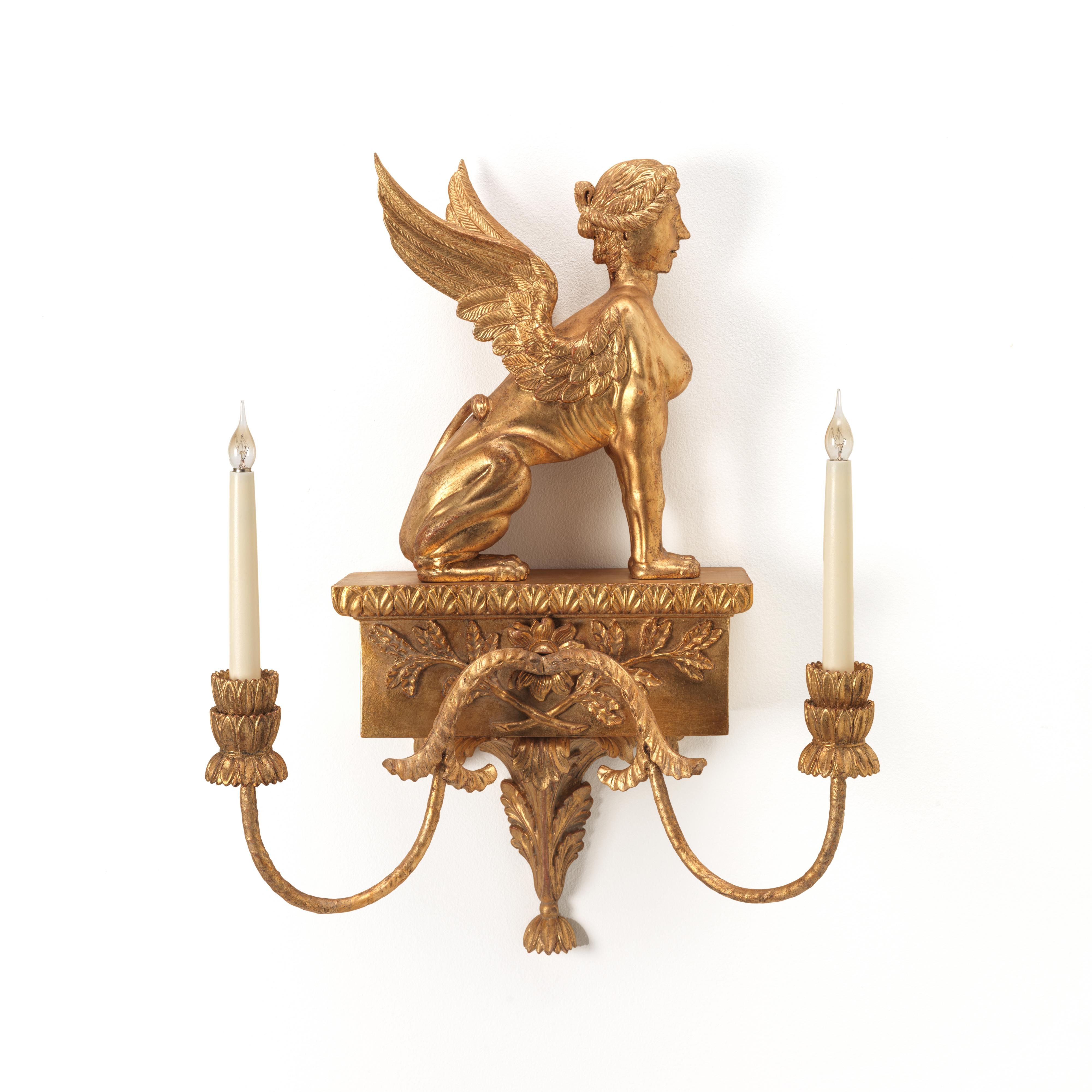 A fine George III design carved giltwood twin branch wall light. The finely carved winged sphynx seated upon a foliate carved plinth, fitted with two scrolling candle arms. Note, can be available as pairs handed left and right facing. Can be