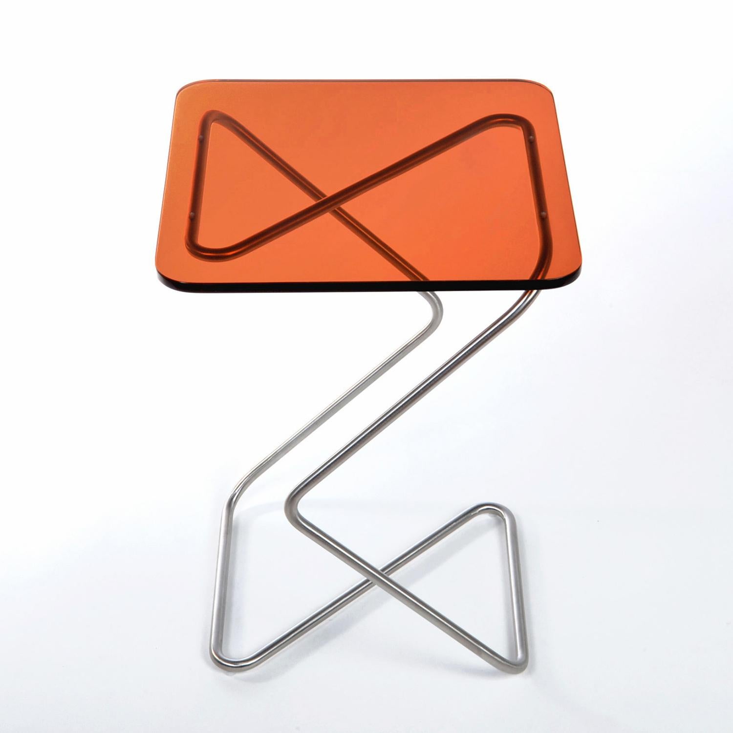 The square side table by Rita Kettaneh
Dimensions: The base: brushed stainless steel 
 optionally plated with copper or brass
 The top: acrylic
Materials: H 46 x W 33 x D 33 cm
Weight: 3.75 Kg

Colors and finishes: 
Stainless finish: Burnt