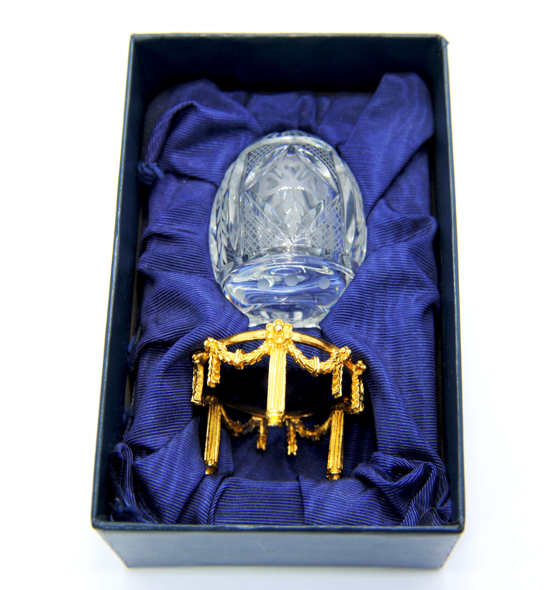 The Fabergé egg is the symbol of spiritual and physical rebirth and renewal.  
This crystal egg is signed and numbered  0475
Fabergé eggs are handcrafted in St. Petersburg.  Russia.
Introduced in 1995
The base is sterling silver gold plated.
size of