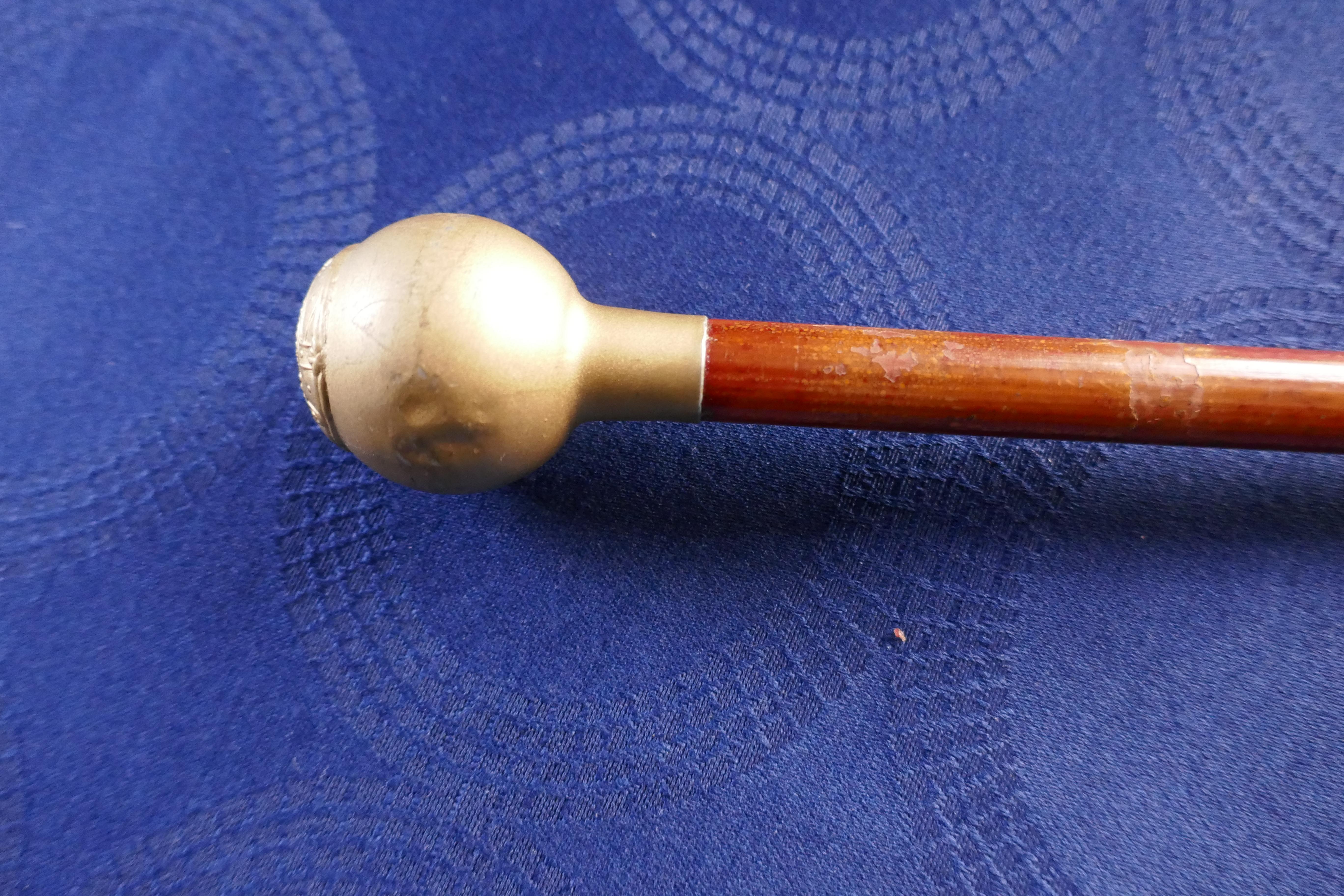 CANFORD SCHOOL O.T.C. swagger stick.

The stick has CANFORD SCHOOL O.T.C. crest on the round head
The metal top appears to be a white metal overprinted to look like brass
The stick has a strong cane shaft and an original metal ferrule

The