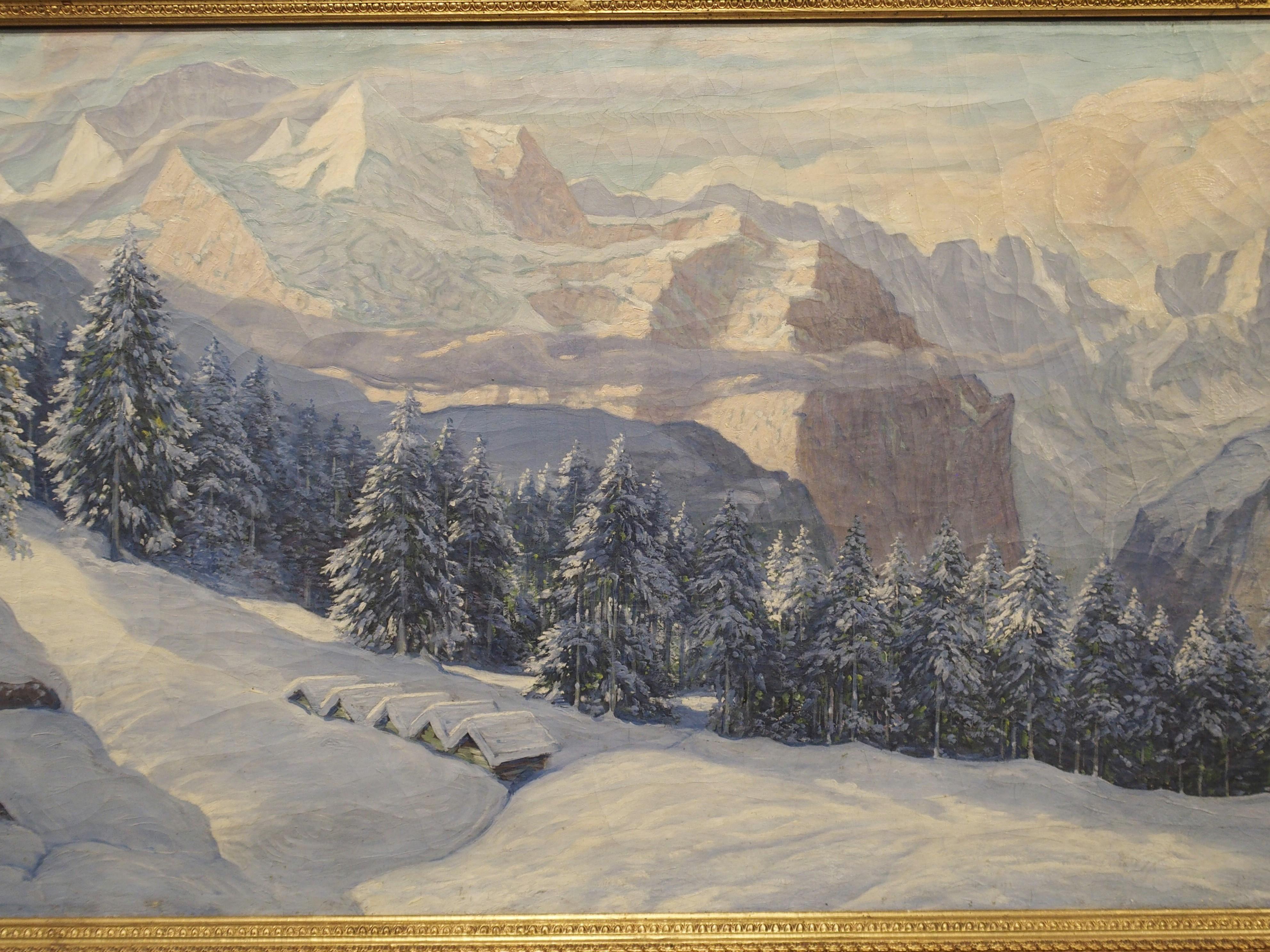 This majestic landscape painting at nearly 5 feet long (including frame) depicts a grand mountain view of the Swiss Alps in winter. It was painted by the Swiss artist Hans August Haas, born 1866 in Basel. The view looking down the pine tree covered