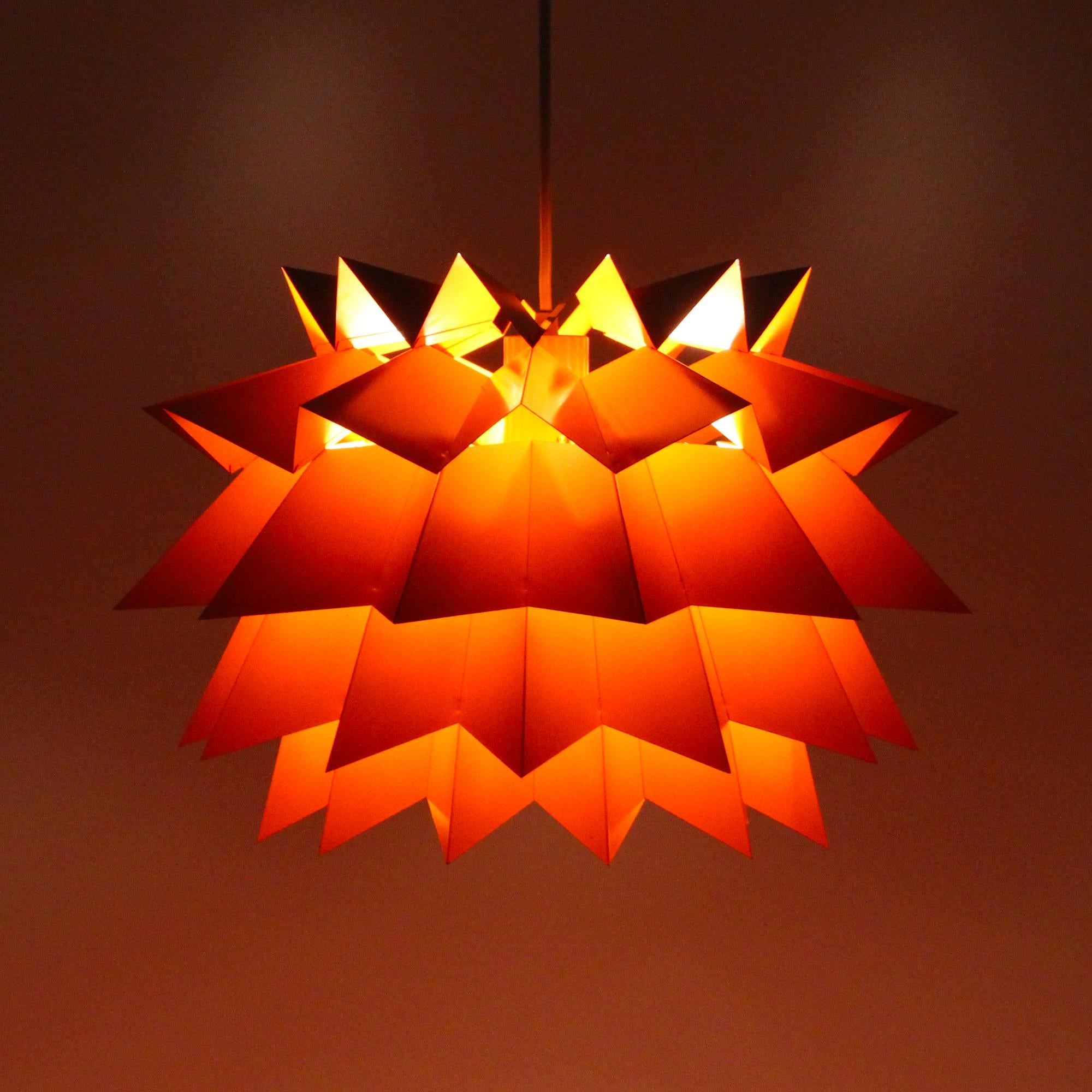 The Sydney light by Anton Fogh Holm & Alfred J Andersen for Nordisk Solar Compagni in the 1960s, rare and beautiful orange lamp in good vintage condition.

An impressive pendant light comprised of five tiers of orange lacquered metal. Each layer