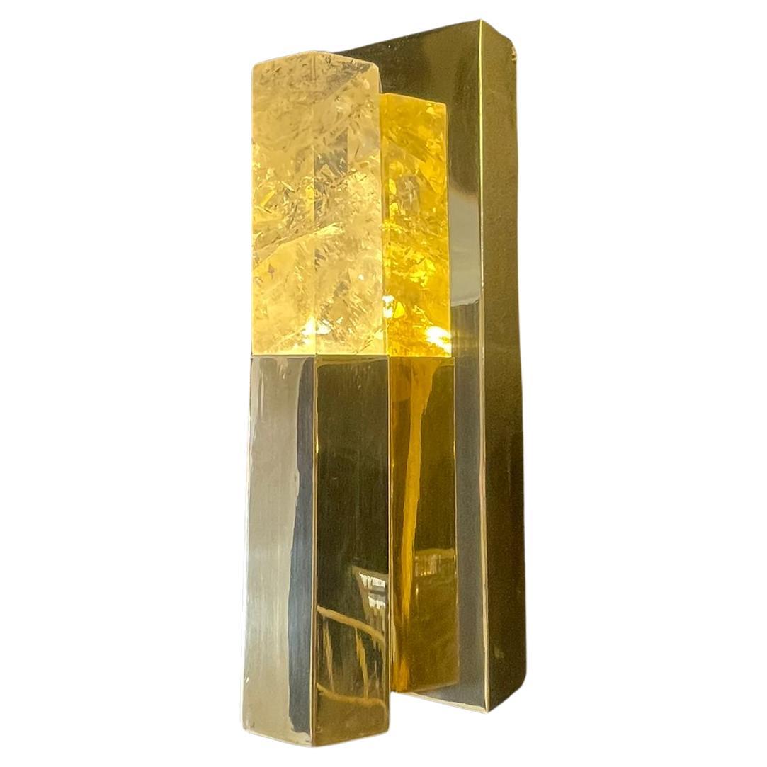 The Tangier wall lamp is the perfect combination of golden brass and white rock crystal in the form of hexagonal tubes. The crystal sits within the brass lamp with a light shining from below, amplifying the crystals beautiful formation.

The crystal