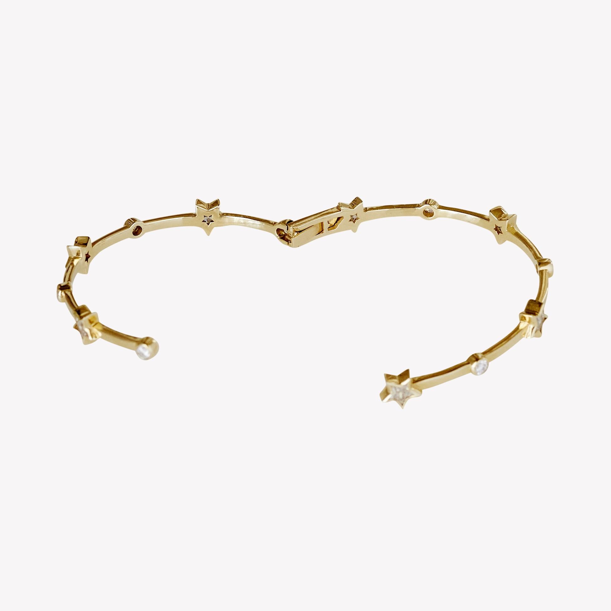 The Thea Bangle: A bold ode to Art Deco elegance, this sculptural wrap-around bangle fuses architectural precision with rich ornamentation. Handcrafted in 18k recycled yellow gold, the design draws on the clean lines and dynamic symmetry that