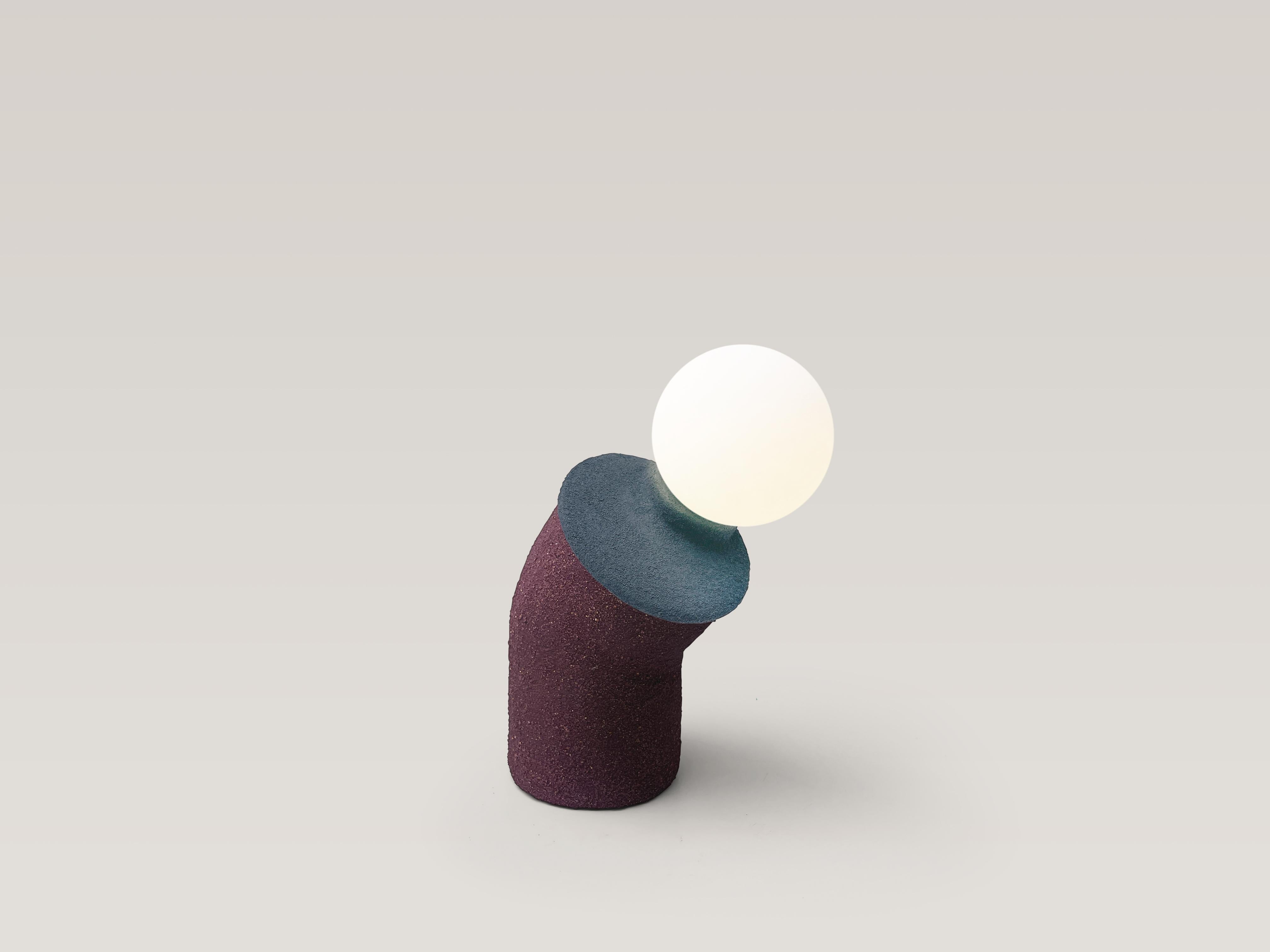 Playful table lamp. Unique piece.

Material: clay, reclaimed plastic, PVA, sand, acrylic paint, pigment, polyurethane, electrical components, glass globe, led dimmable bulb.