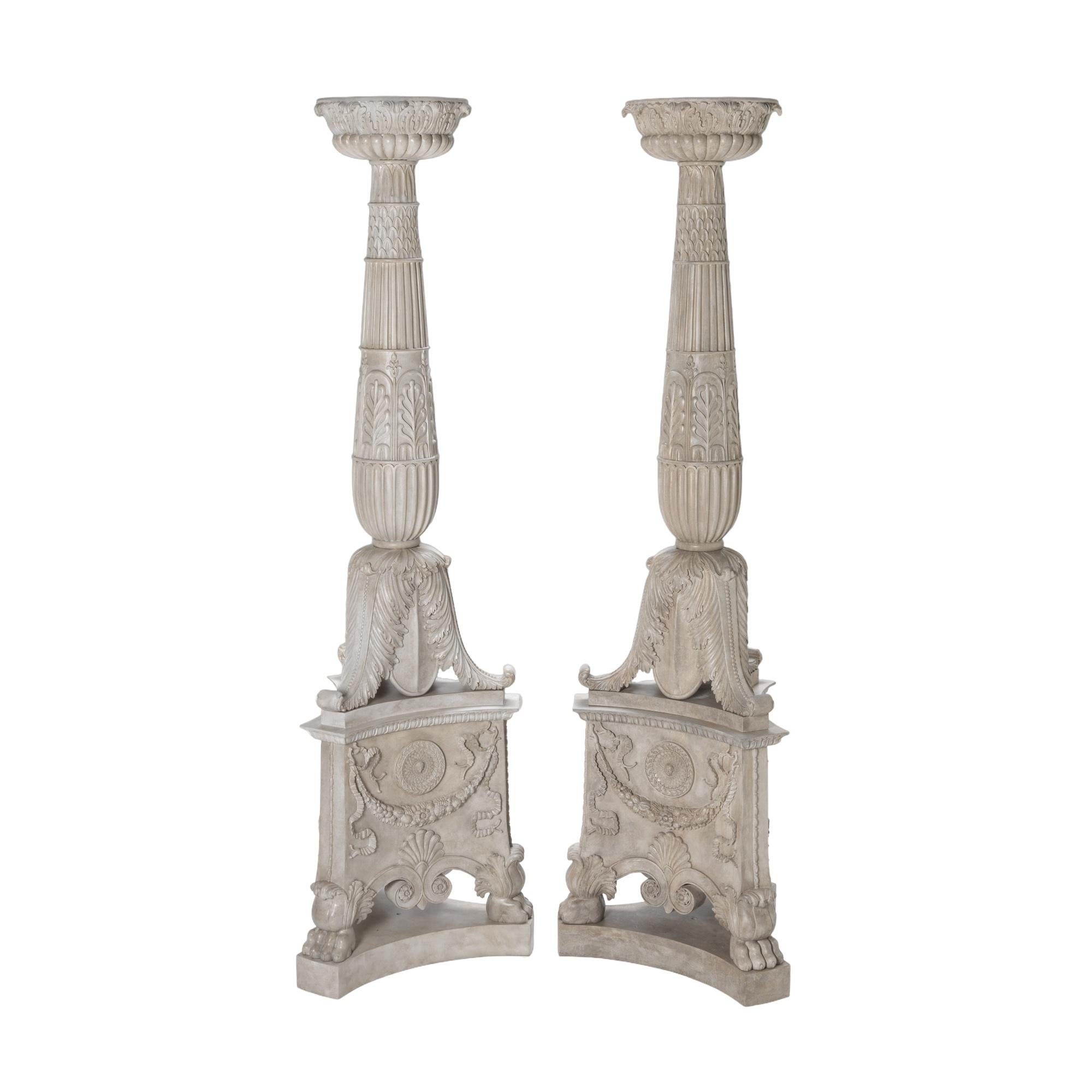 A monumental pair of finely carved Mahogany Grand Tour design specialist aged painted and gesso decorated torcheres.