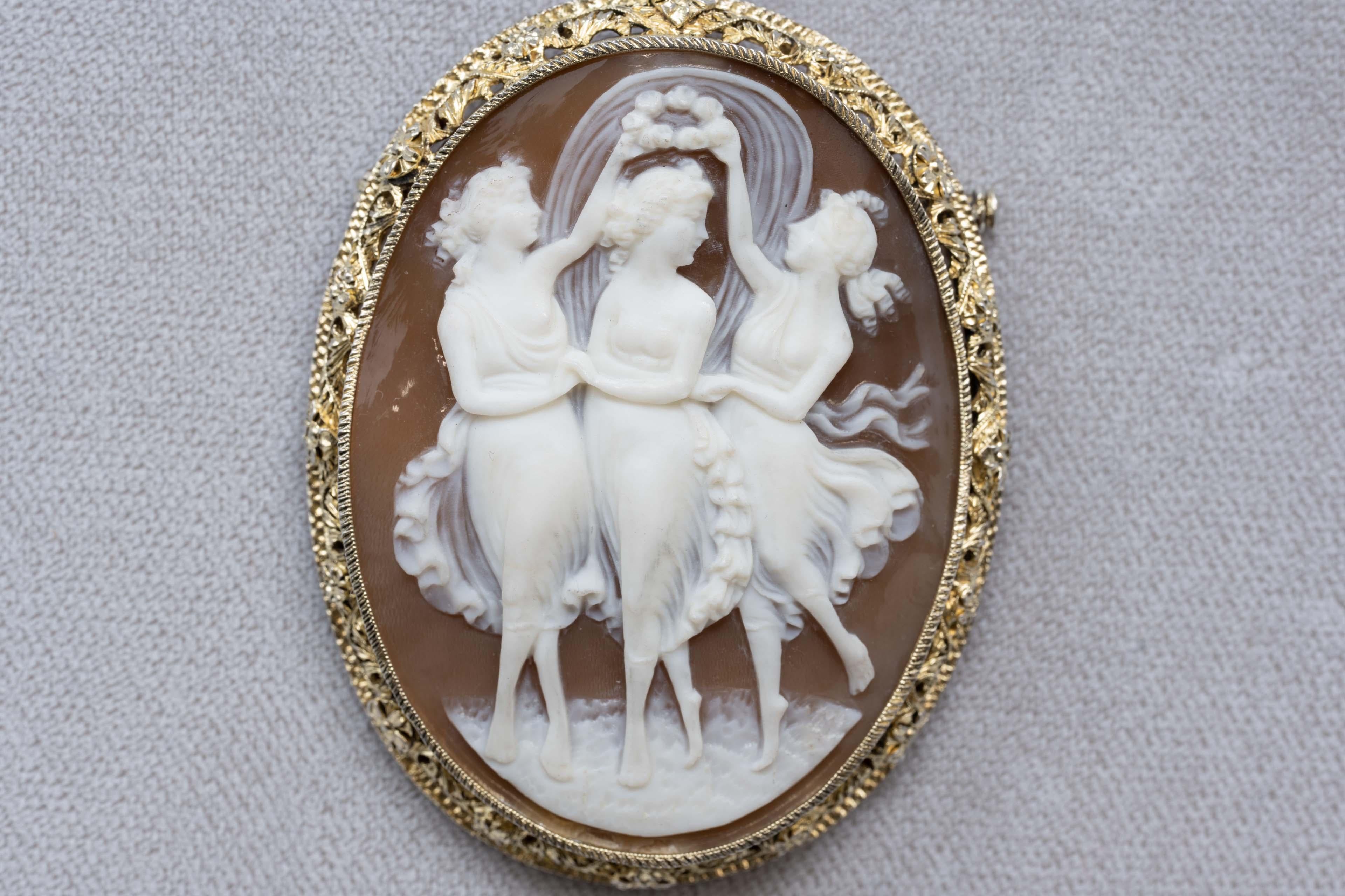 Victorian carved cameo shell of the three graces set in a gold-plated silver mount brooch/pendant. Finely carved and designed, the cameo measures 2 inches long x 1.5 inches wide and 2 1/2 inches x 1 3/4 inches with the frame. Not marked, Made in