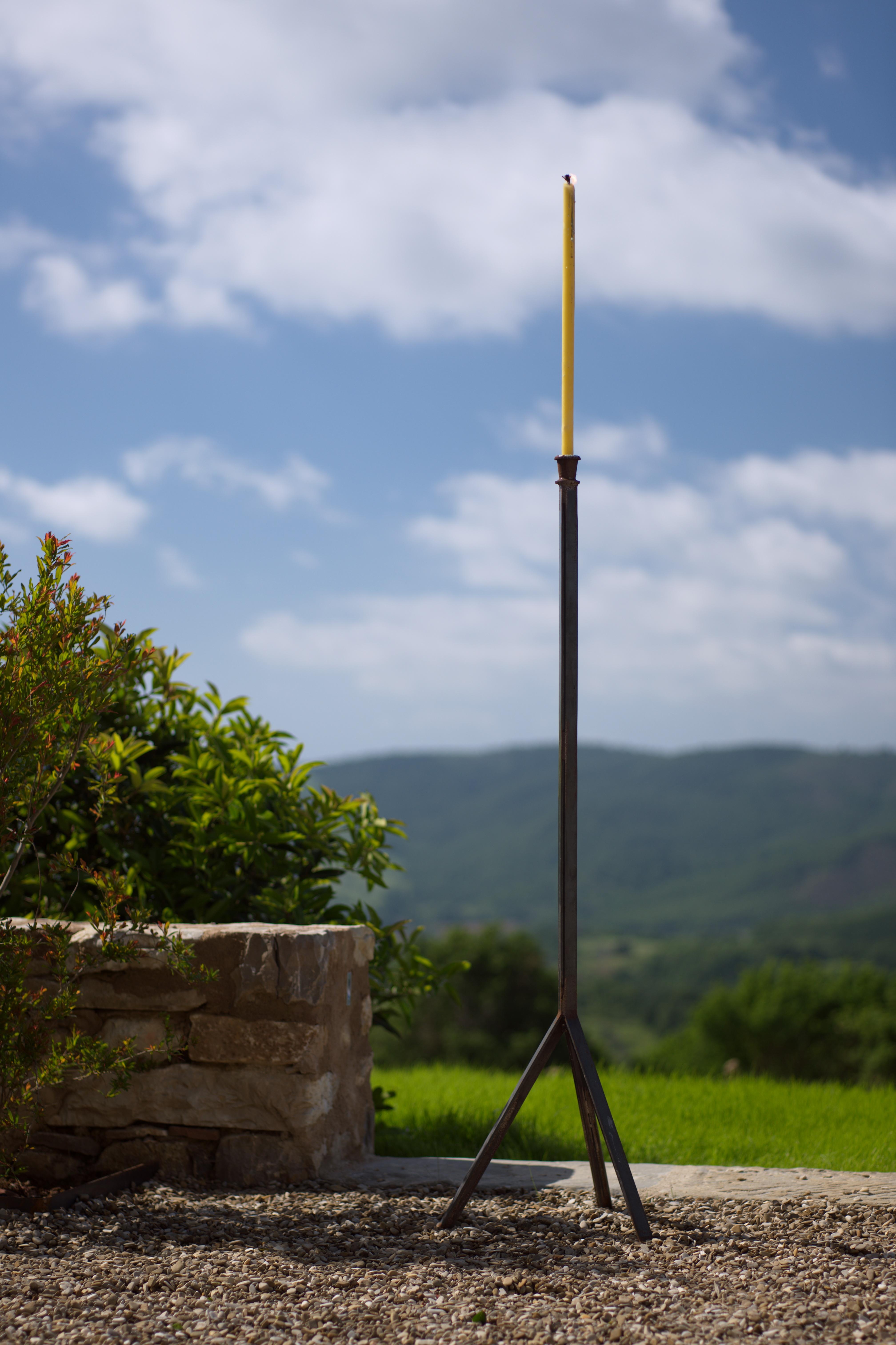 An iron torchère on simple tripod base
These come together with six Sicilian candles, the heavy wicks producing a wonderful flickering outdoor light.
Specifications: untreated steel.



  